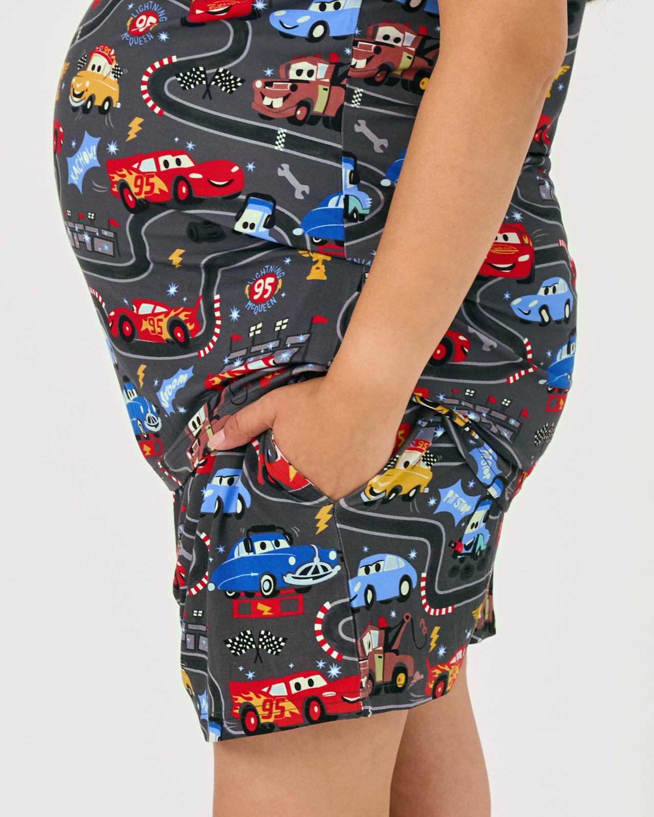 Side view of woman wearing the Disney & Pixar Piston Cup Women's Pajama Shorts