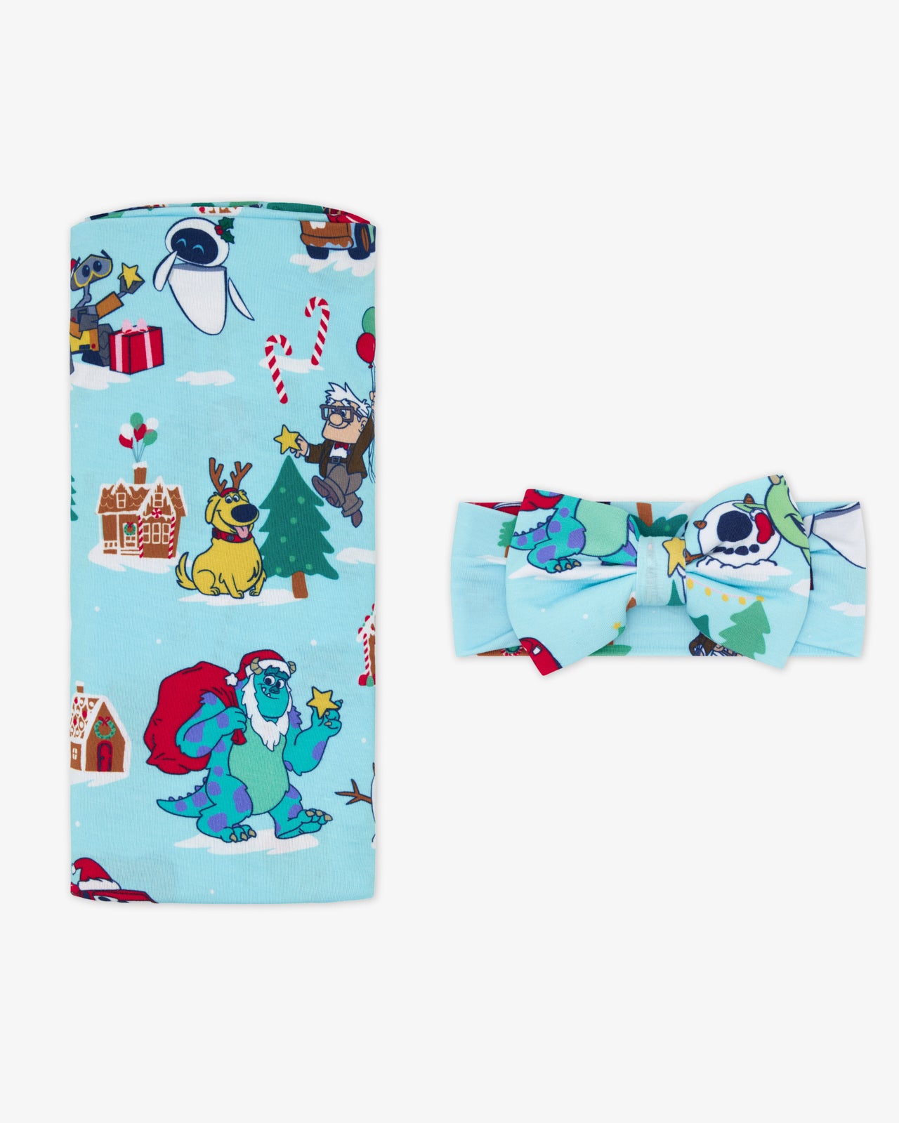 Flat lay of the Disney & Pixar Christmas Village Swaddle & Luxe Bow Headband Set