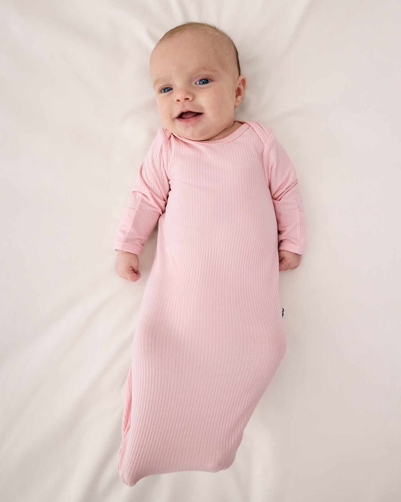 Aerial view of baby wearing the Prima Pink Ribbed Infant Gown