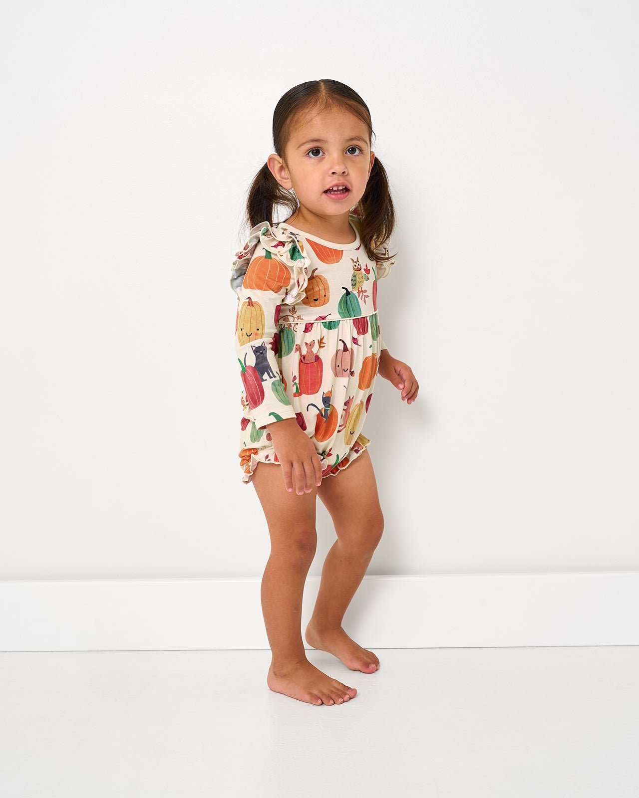 Walking toddler wearing the Pumpkin Pals Bubble Romper