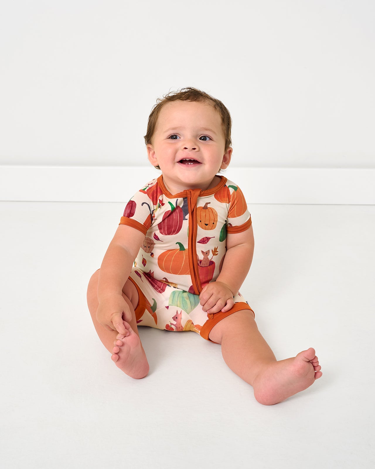 Sitting baby wearing the Pumpkin Pals Shorty Zippy