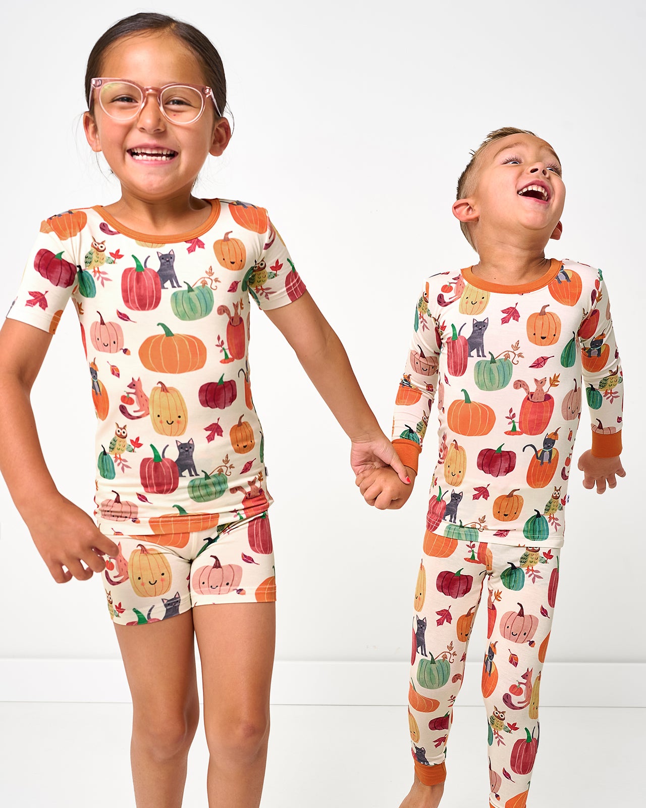 Two kids wearing matching Pumpkin Pals Two-Piece PJ sets