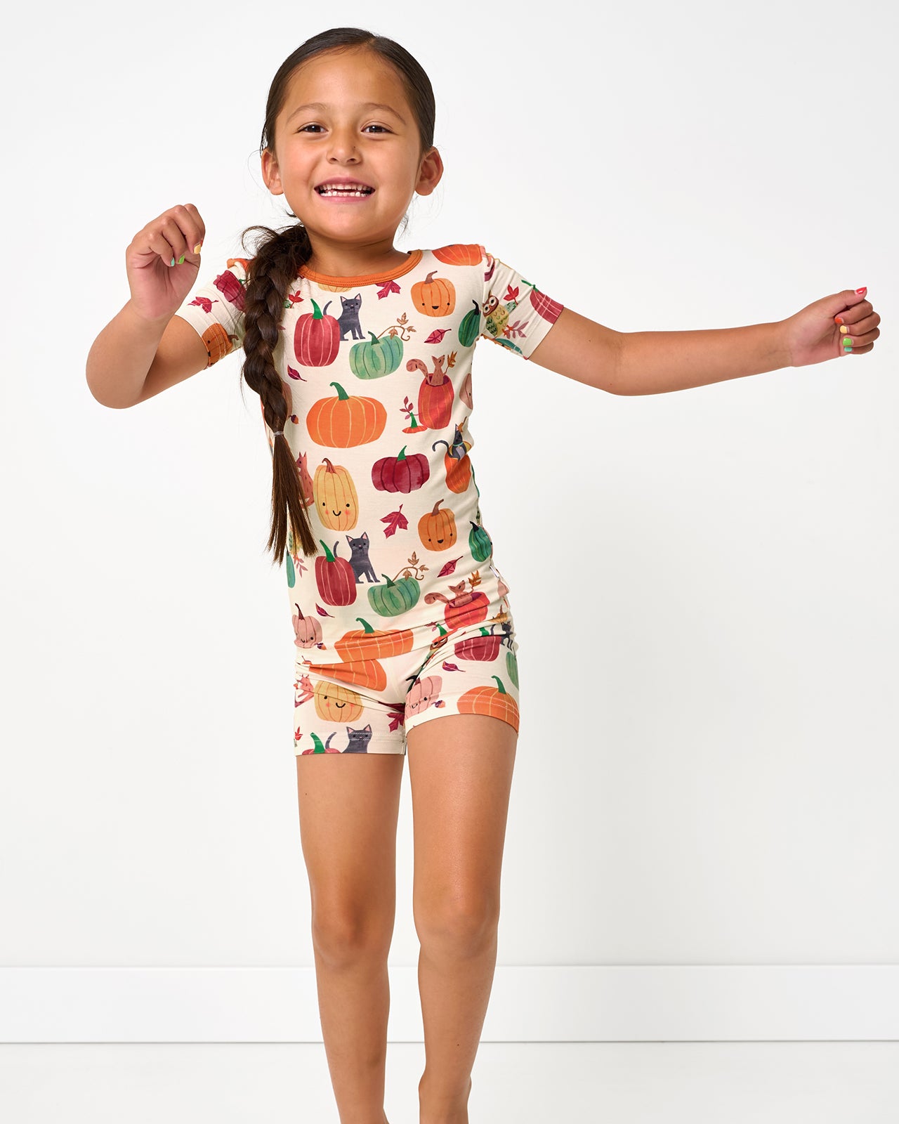 Posing girl wearing the Pumpkin Pals Two-Piece Short Sleeve & Shorts Pajama Set