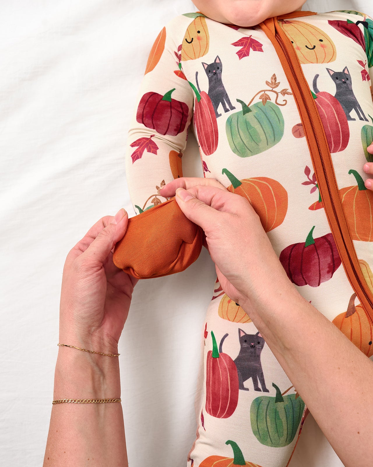 Adult demonstrating the mitten feature on the Pumpkin Pals Zippy