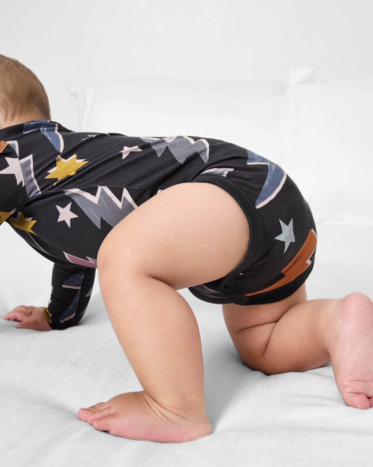 Crawling baby wearing the Rad Bolts Bodysuit