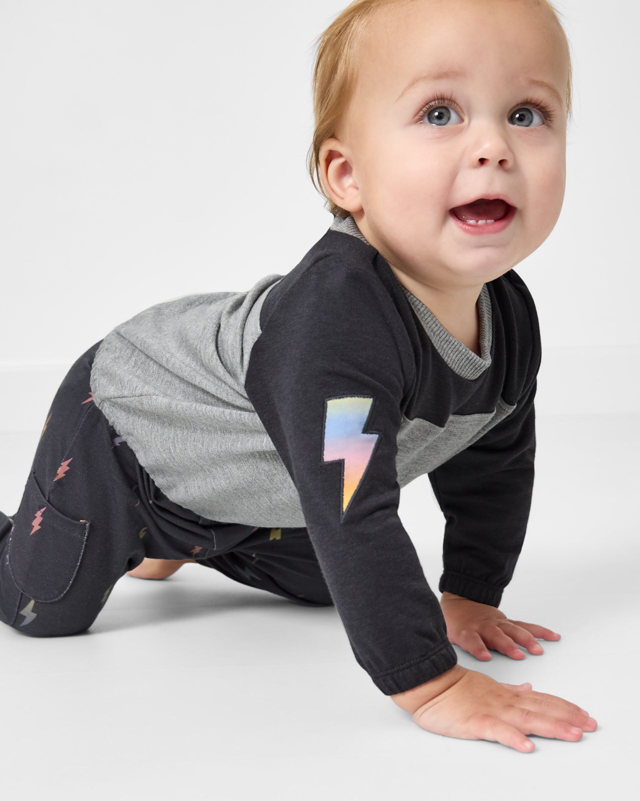 Crawling baby wearing the Rad Bolts Cinched Panel Crewneck