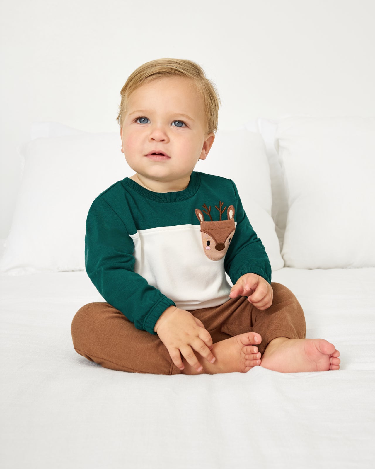 Baby wearing the Reindeer Cinched Pocket Sweatshirt