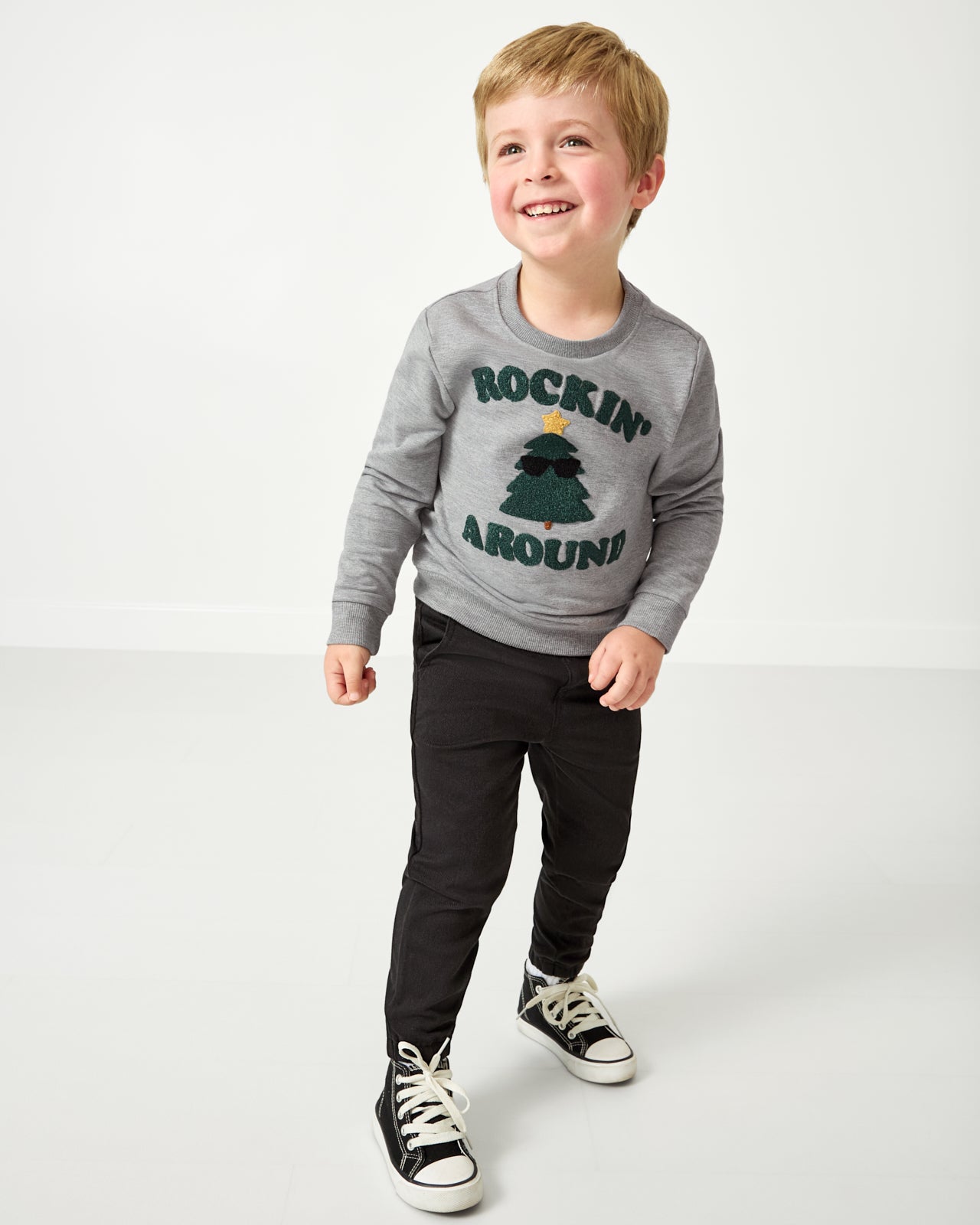 Boy wearing the Rockin' Around Crewneck Sweatshirt with black pants