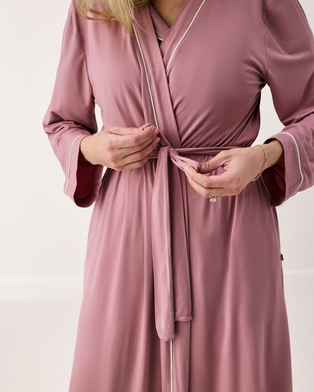 Woman tying the Rosewood Women's Robe
