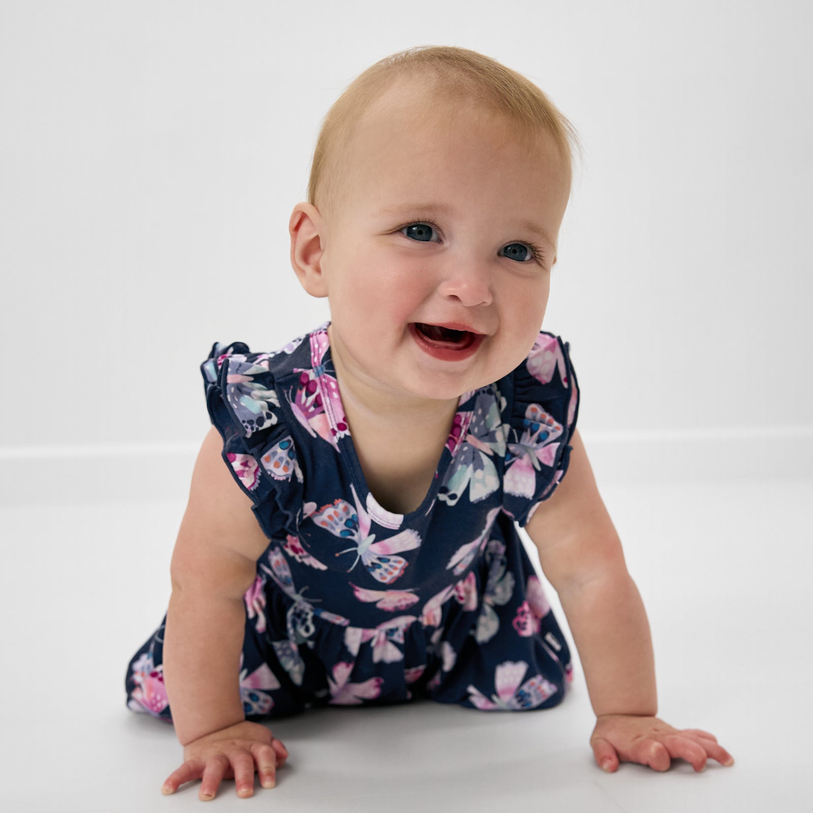 Crawling child wearing the Royal Butterflies Flutter Twirl Dress with Bodysuit