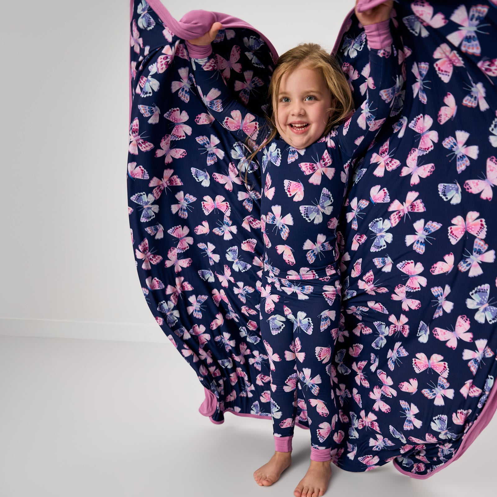 Girl holding up the Royal Butterflies Large Cloud Blanket®