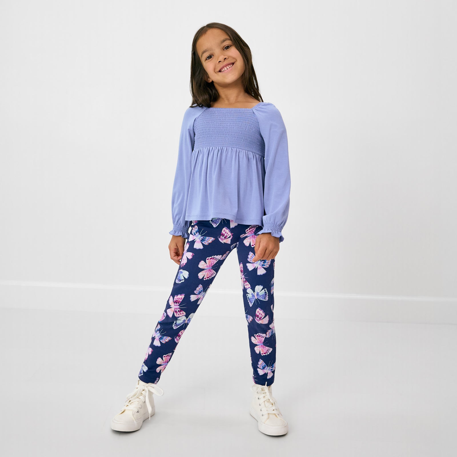 Standing girl wearing the Royal Butterflies Legging with a violet purple top