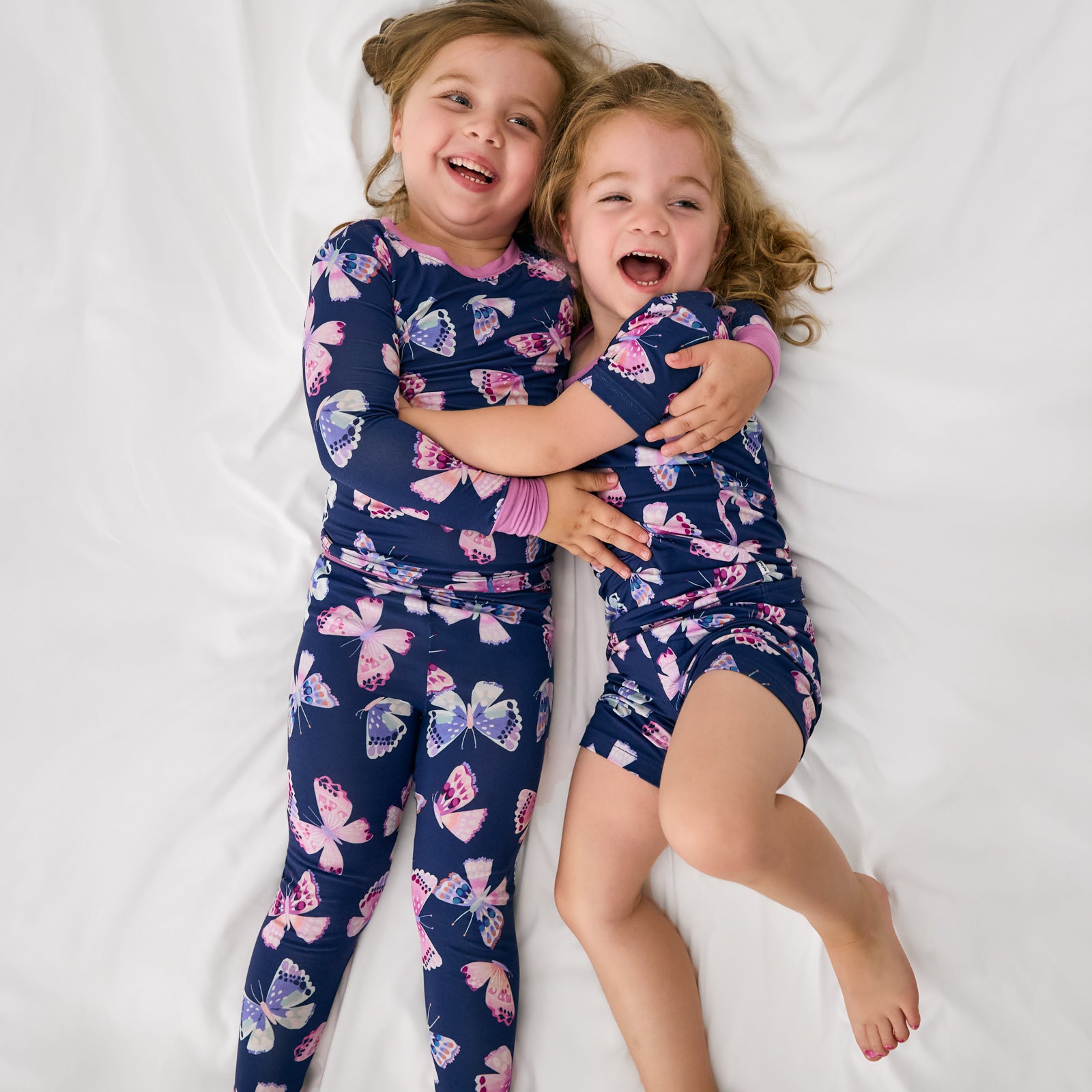 Two children wearing matching Royal Butterflies butterfly printed kids pajama sets