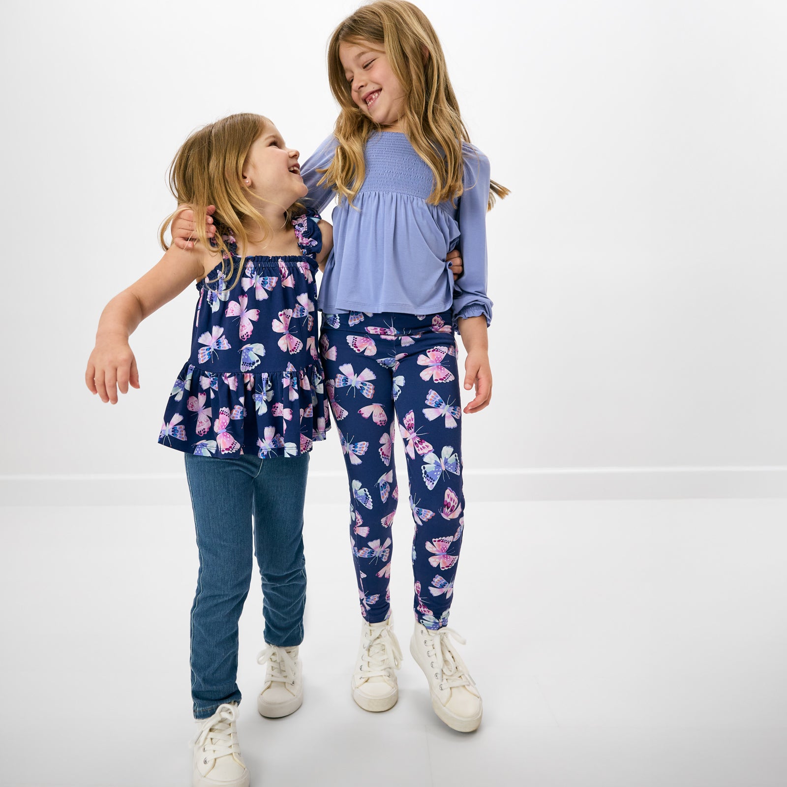 Two children wearing matching Royal Butterflies play styles