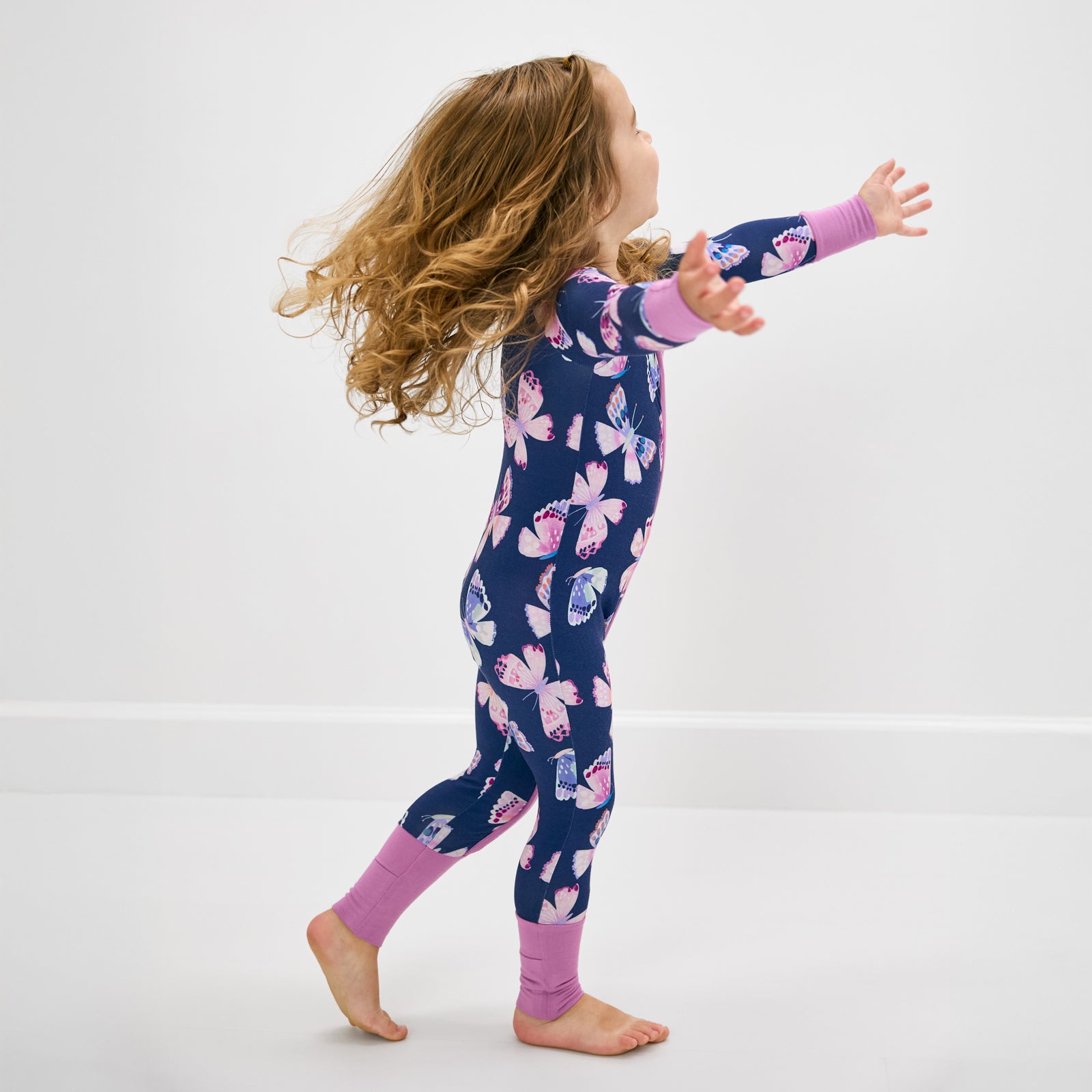 Walking toddler wearing the Royal Butterflies Zippy