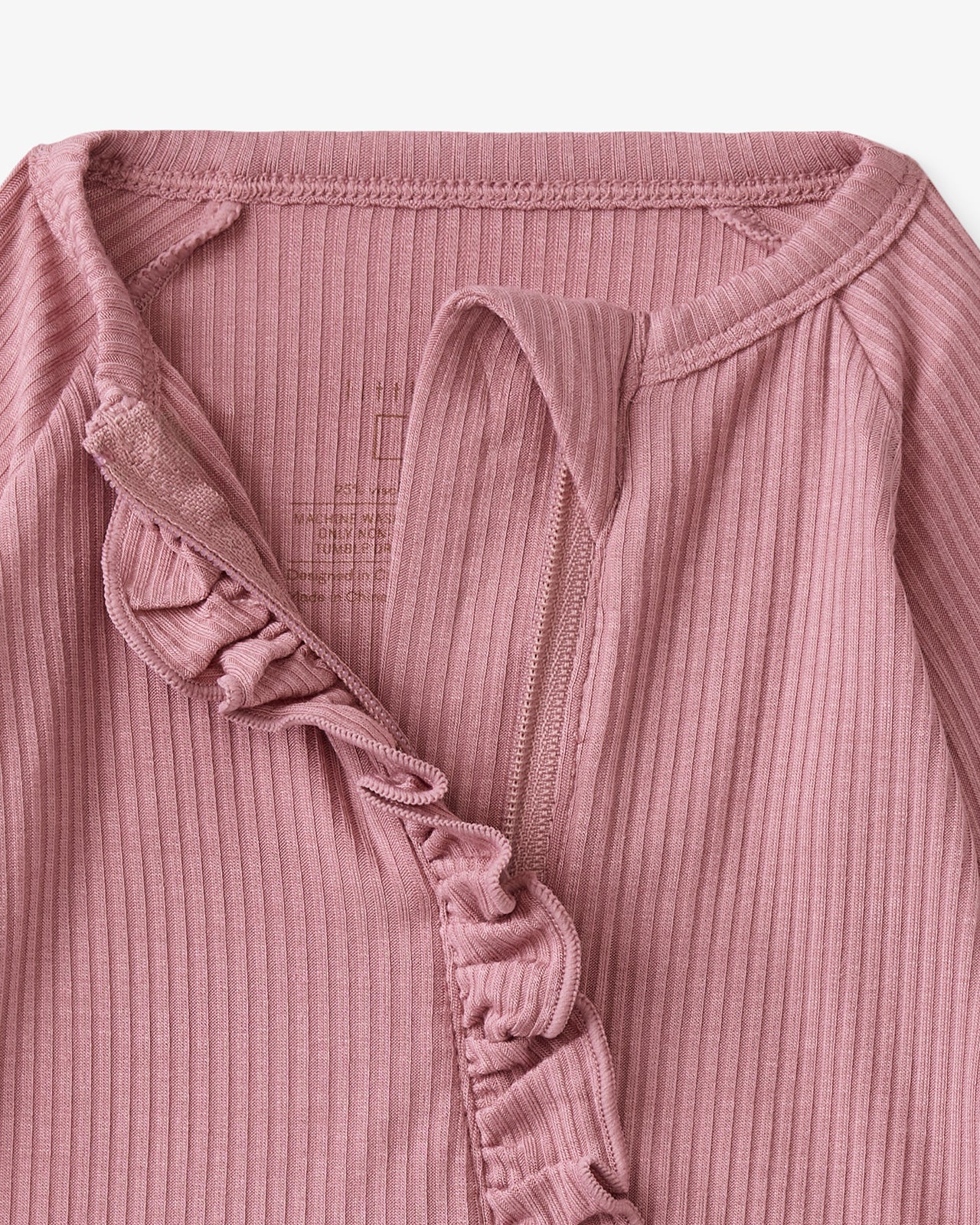 Close up of the neck opening on the Rosewood Ribbed Ruffle Zippy