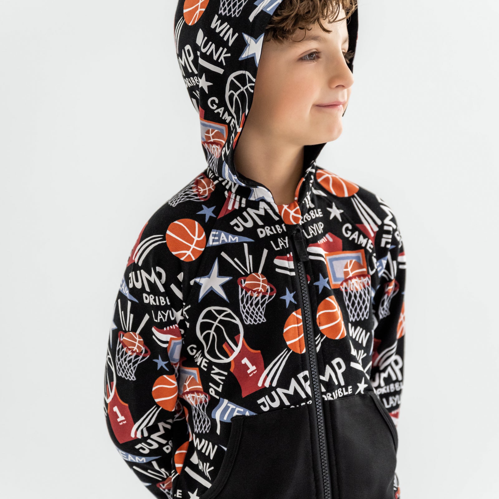 Close up of child wearing the Black Slam Dunk zip hoodie