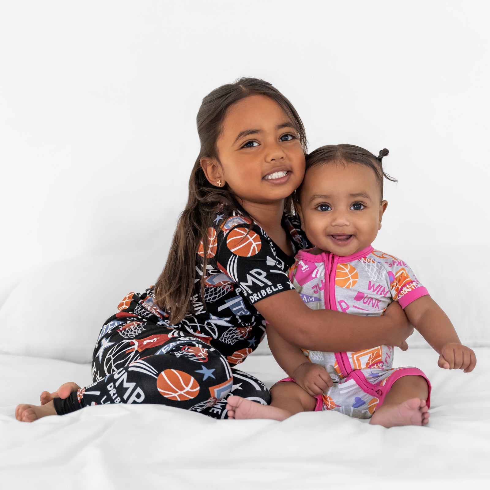 Two children wearing matching Slam Dunk bamboo pajamas