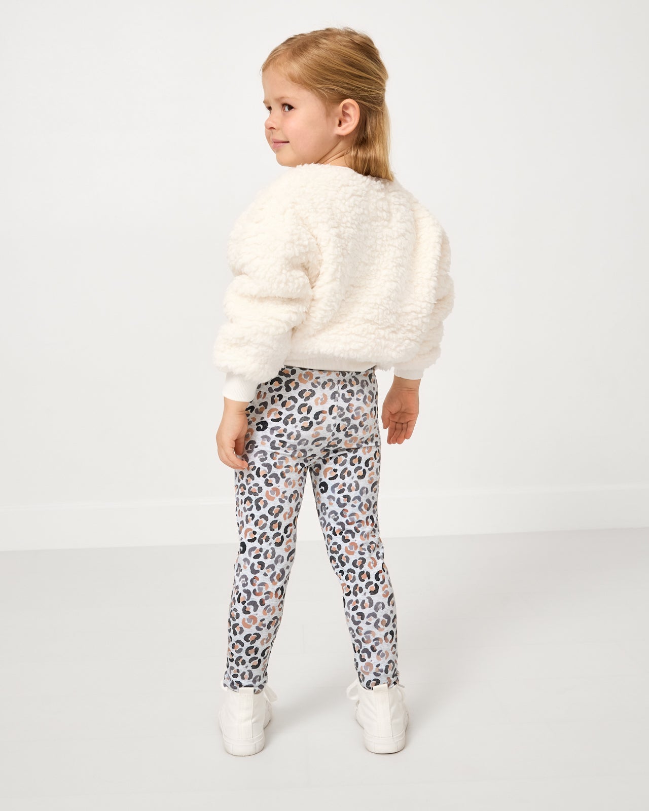 Back view of girl wearing the Leopard Drop Shoulder Crewneck