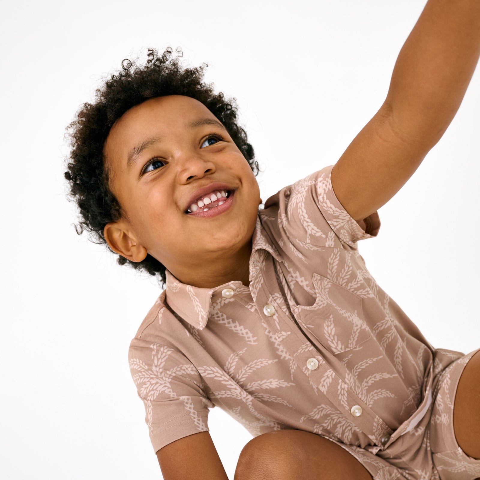 Close up of child wearing the Sandy Palms Button Down Polo