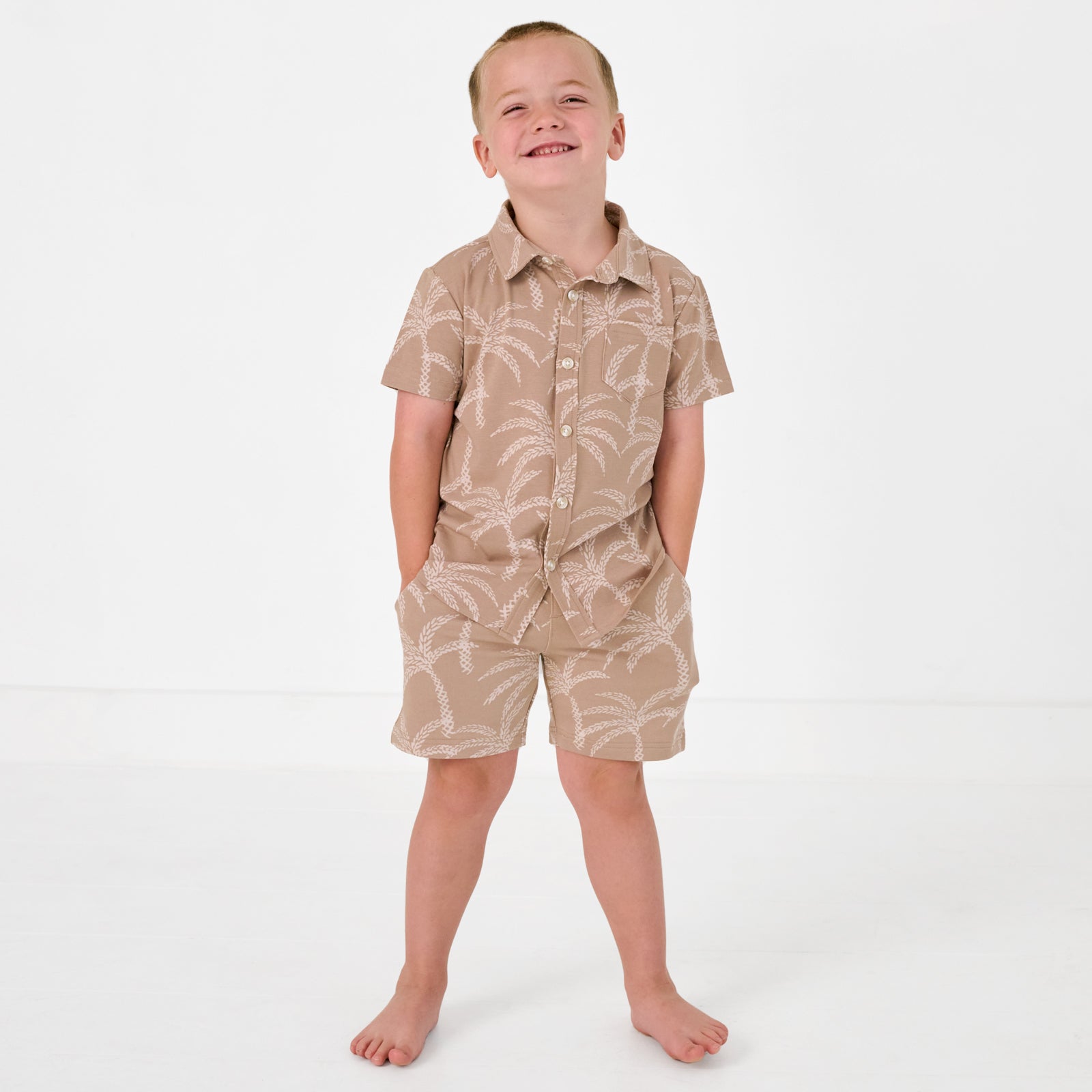 Alternate standing child wearing the Sandy Palms Button Down Polo