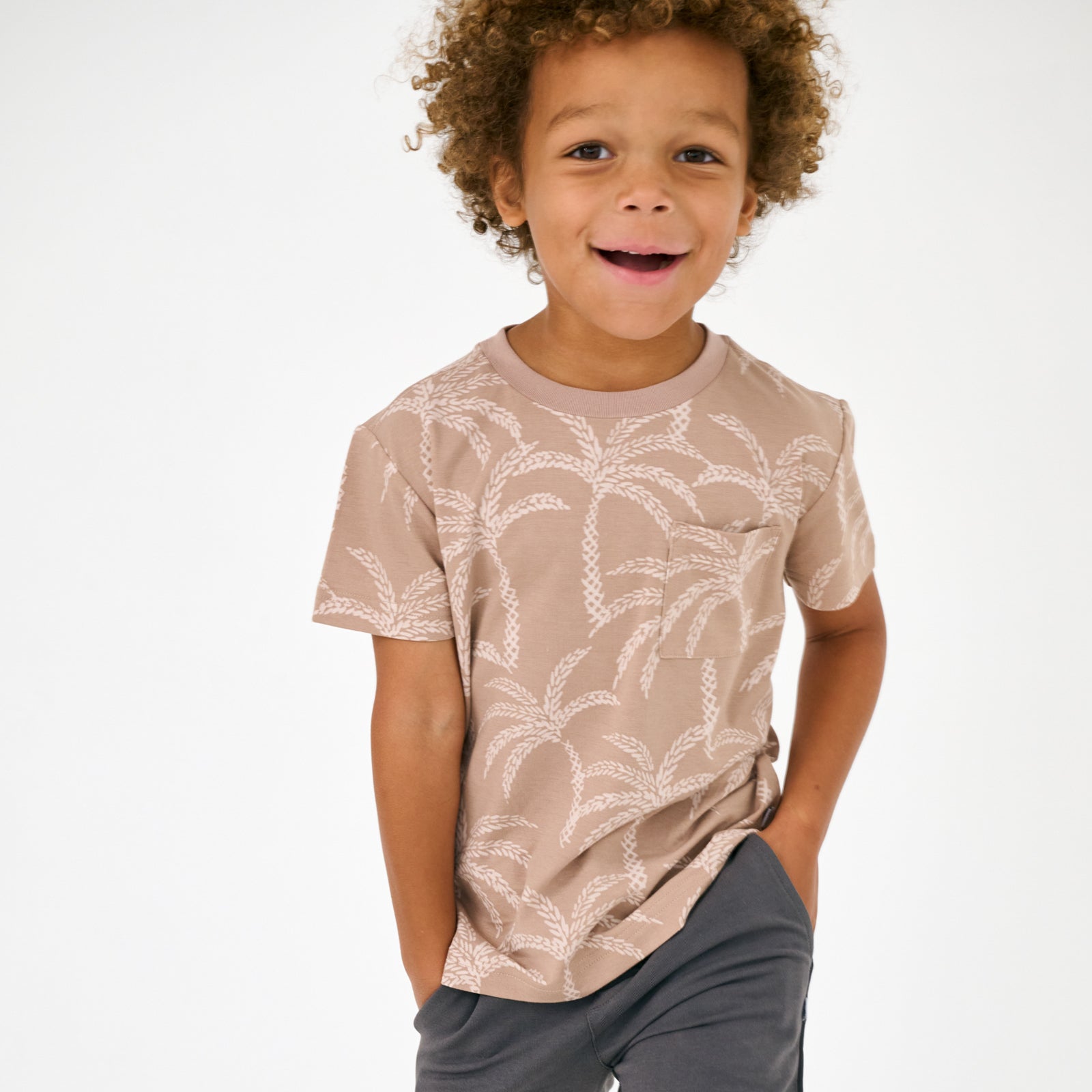 Standing child wearing the Sandy Palms Relaxed Pocket Tee