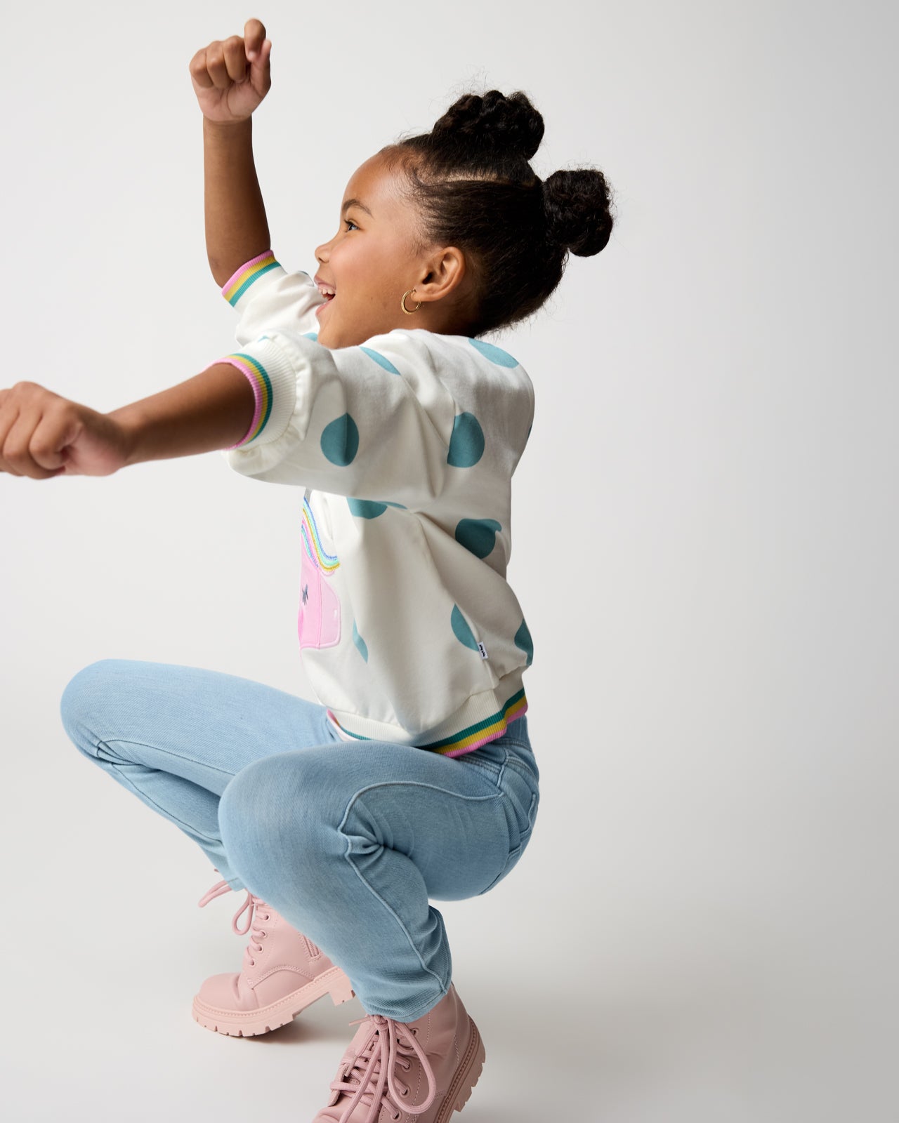 Dancing child wearing the Unicorn Drop Shoulder Crewneck