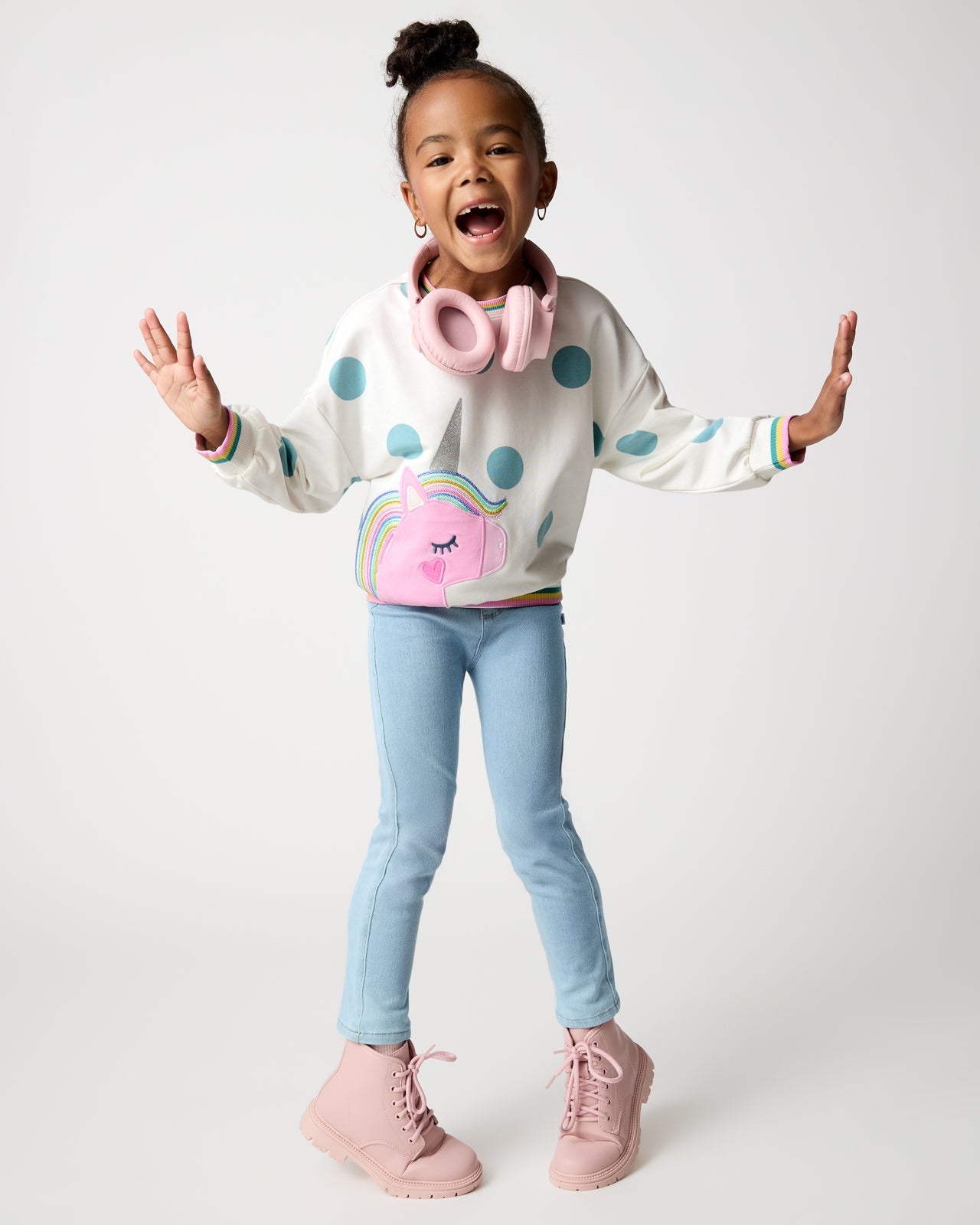 Posing girl wearing the Unicorn Drop Shoulder Crewneck with denim pants