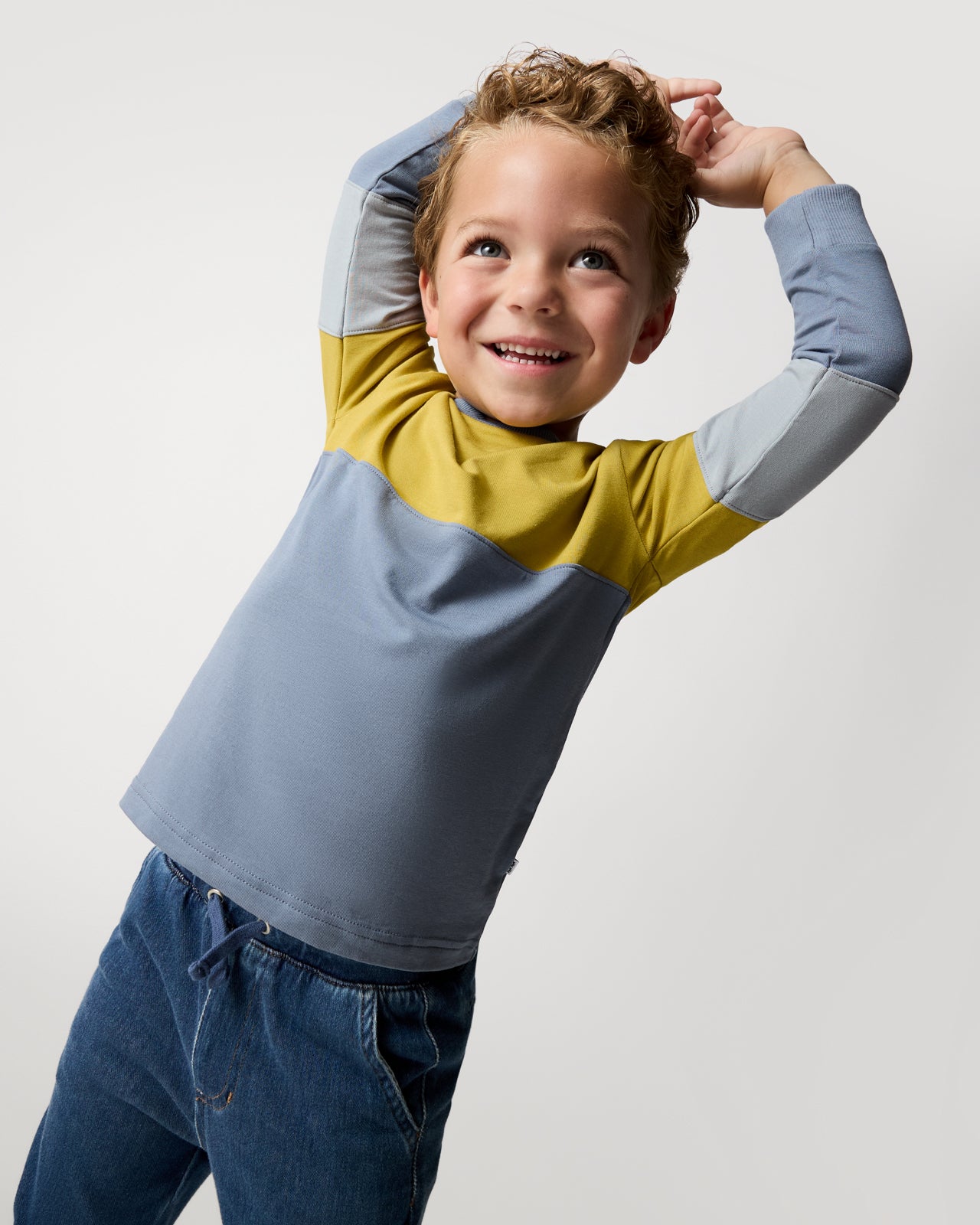Posing boy wearing the Golden Moss Paneled Tee