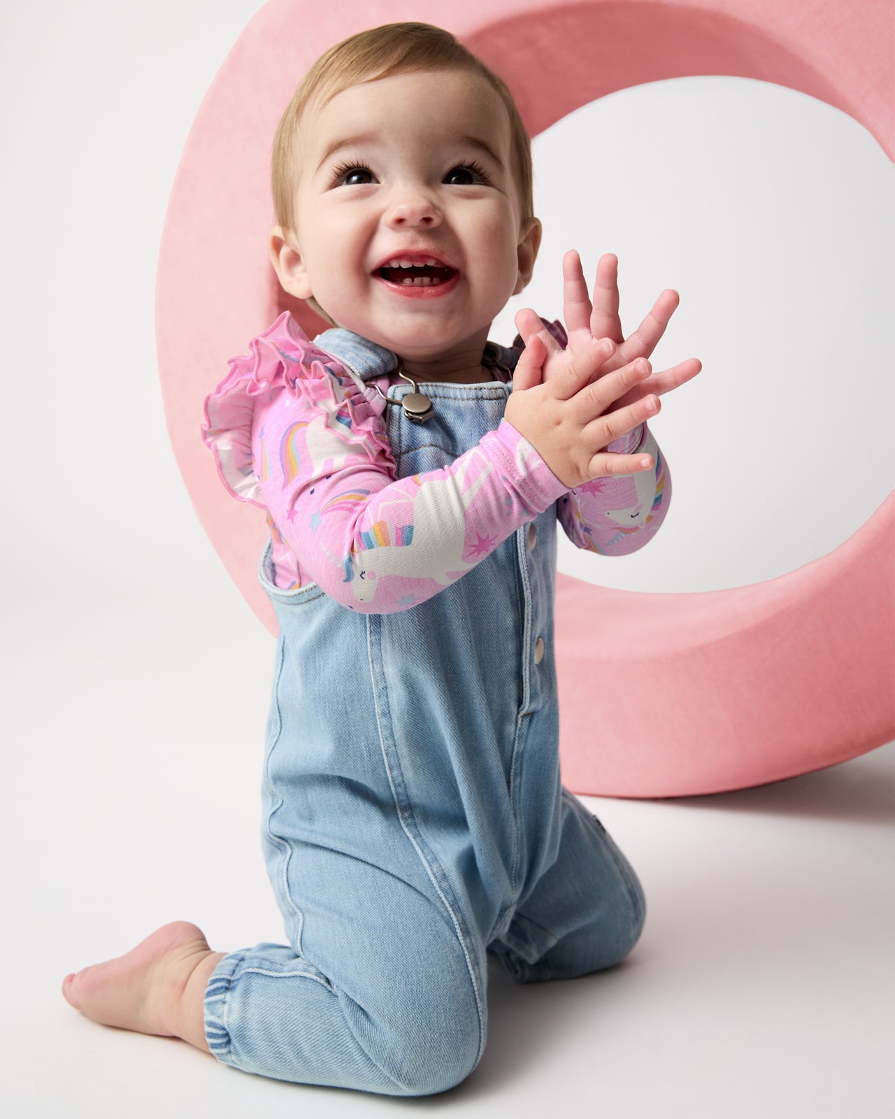 Clapping baby wearing the Unicorn Dance Flutter Bodysuit