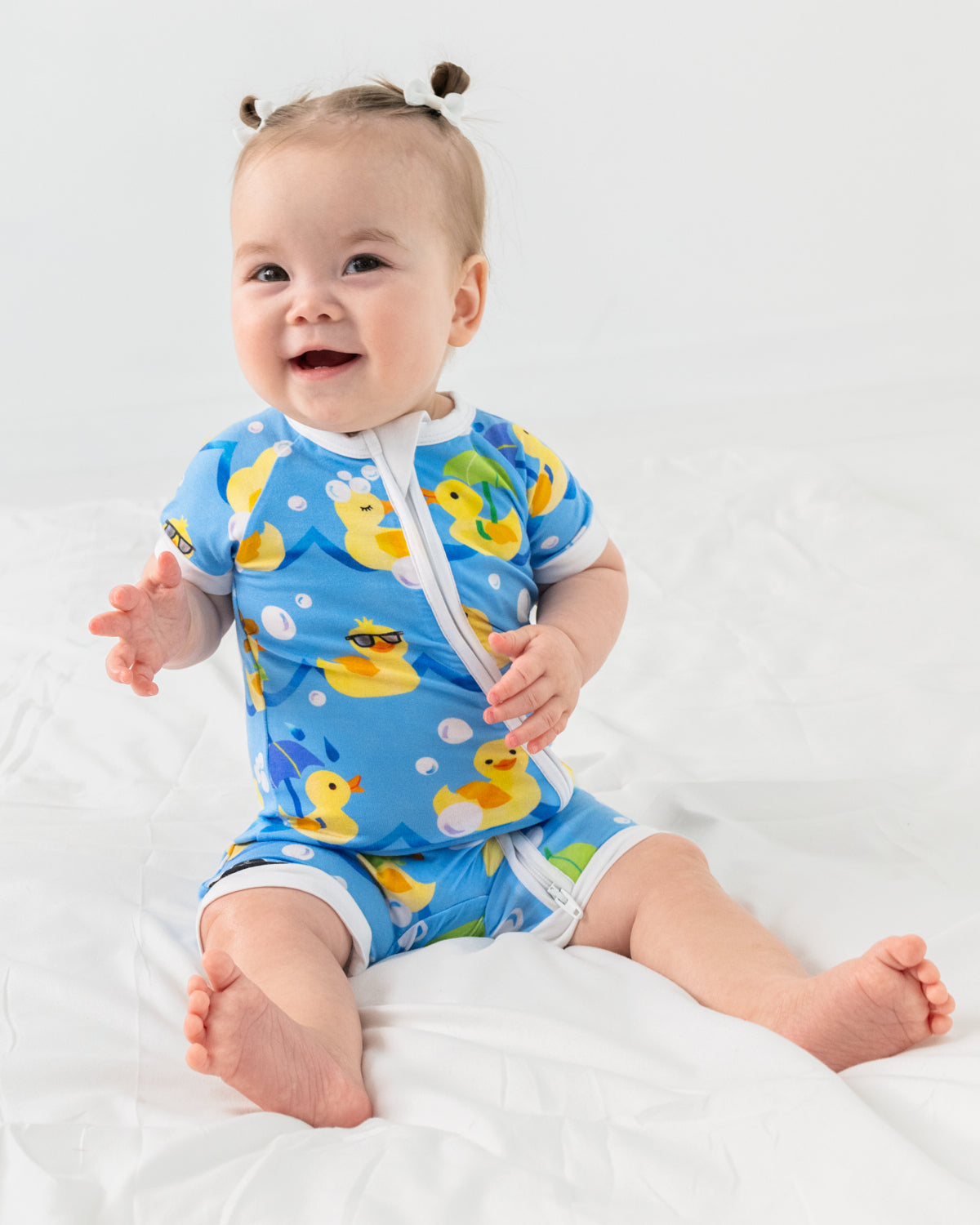 Sitting baby wearing the Splish Splash Shorty Zippy