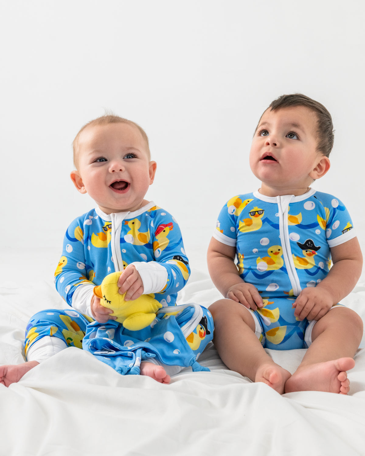 Two babies wearing matching Splish Splash Zippys