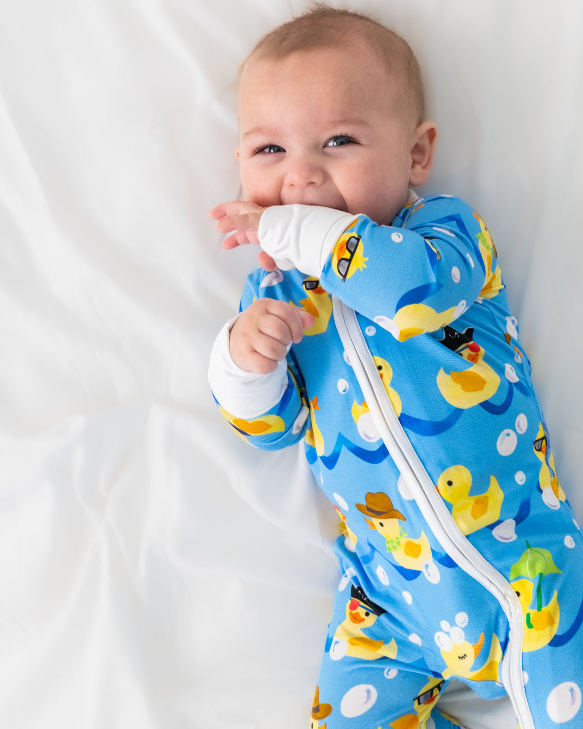 Close up aerial view of baby wearing the Splish Splash Zippy