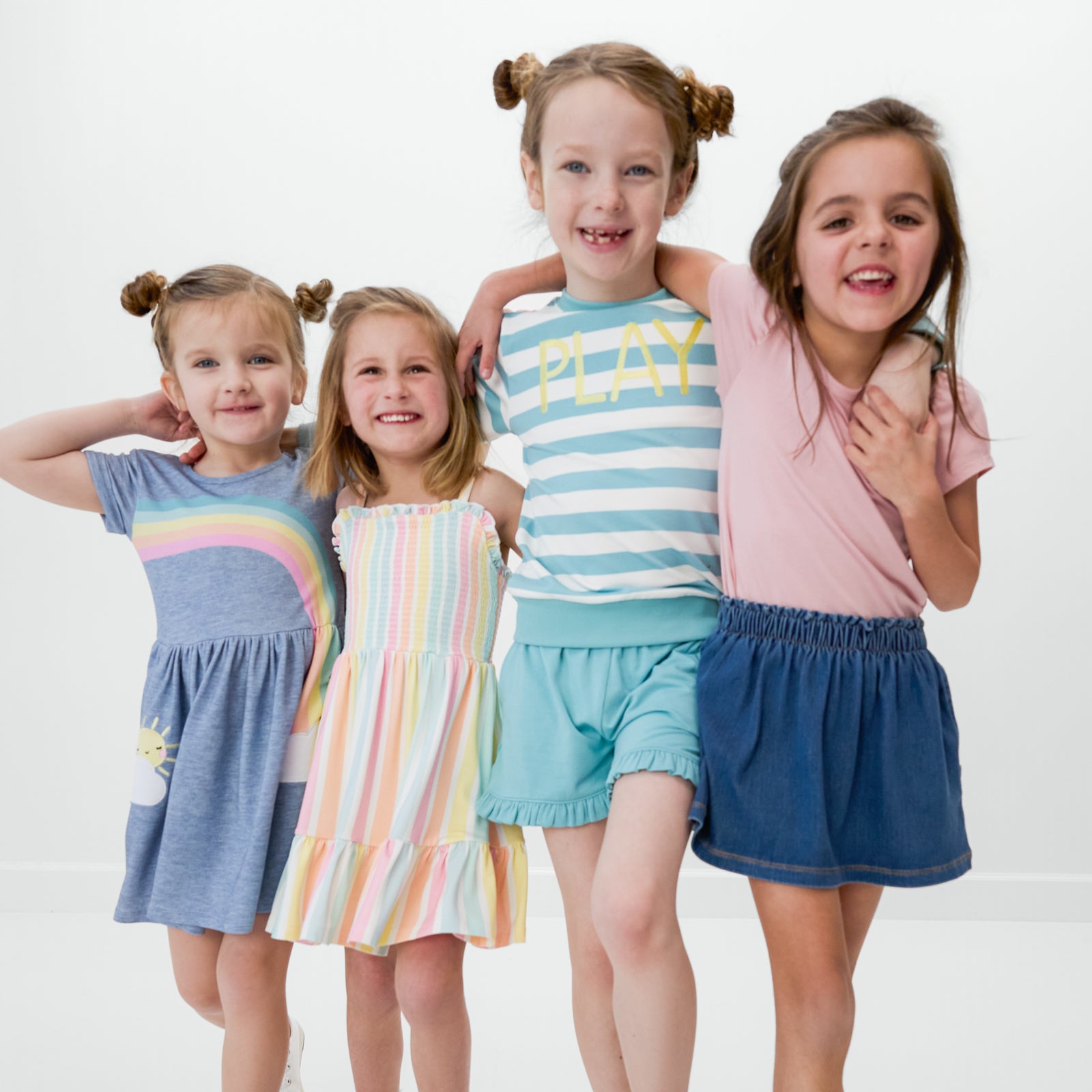 Four children wearing styles from the Spring Play Collection