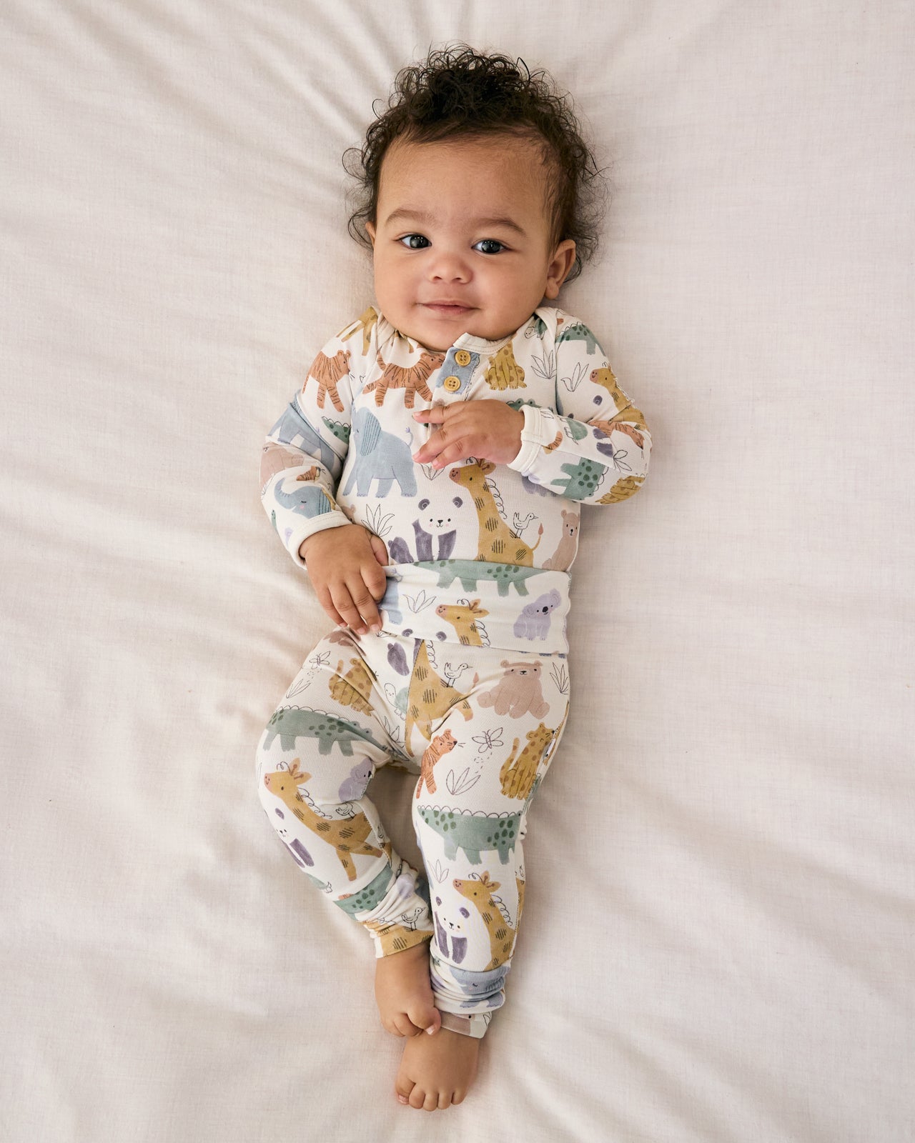 Aerial view of baby wearing the Sweet Safari Henley Bodysuit with coordinating newborn leggings
