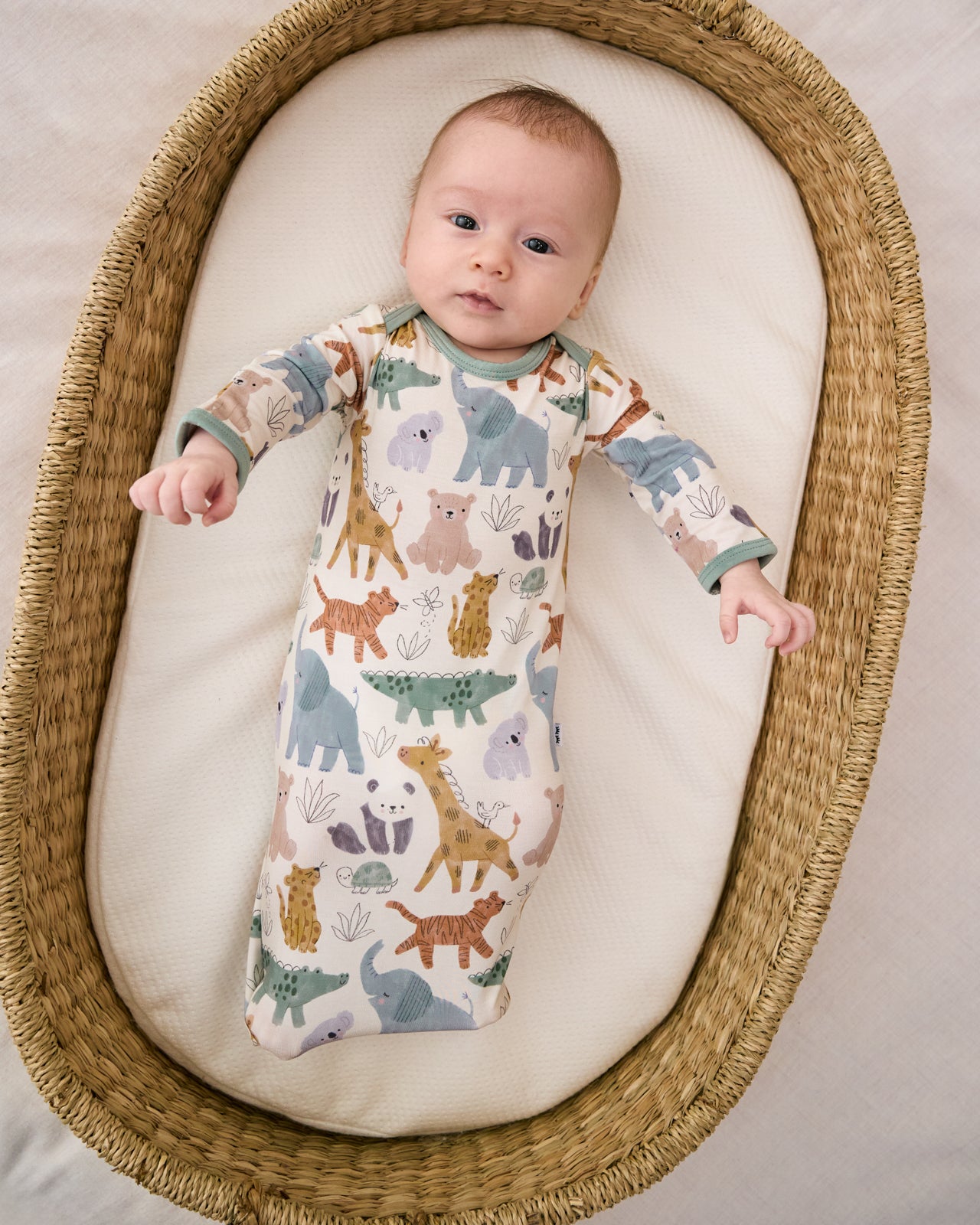 Aerial view of baby in a crib basket wearing the Sweet Safari Infant Gown