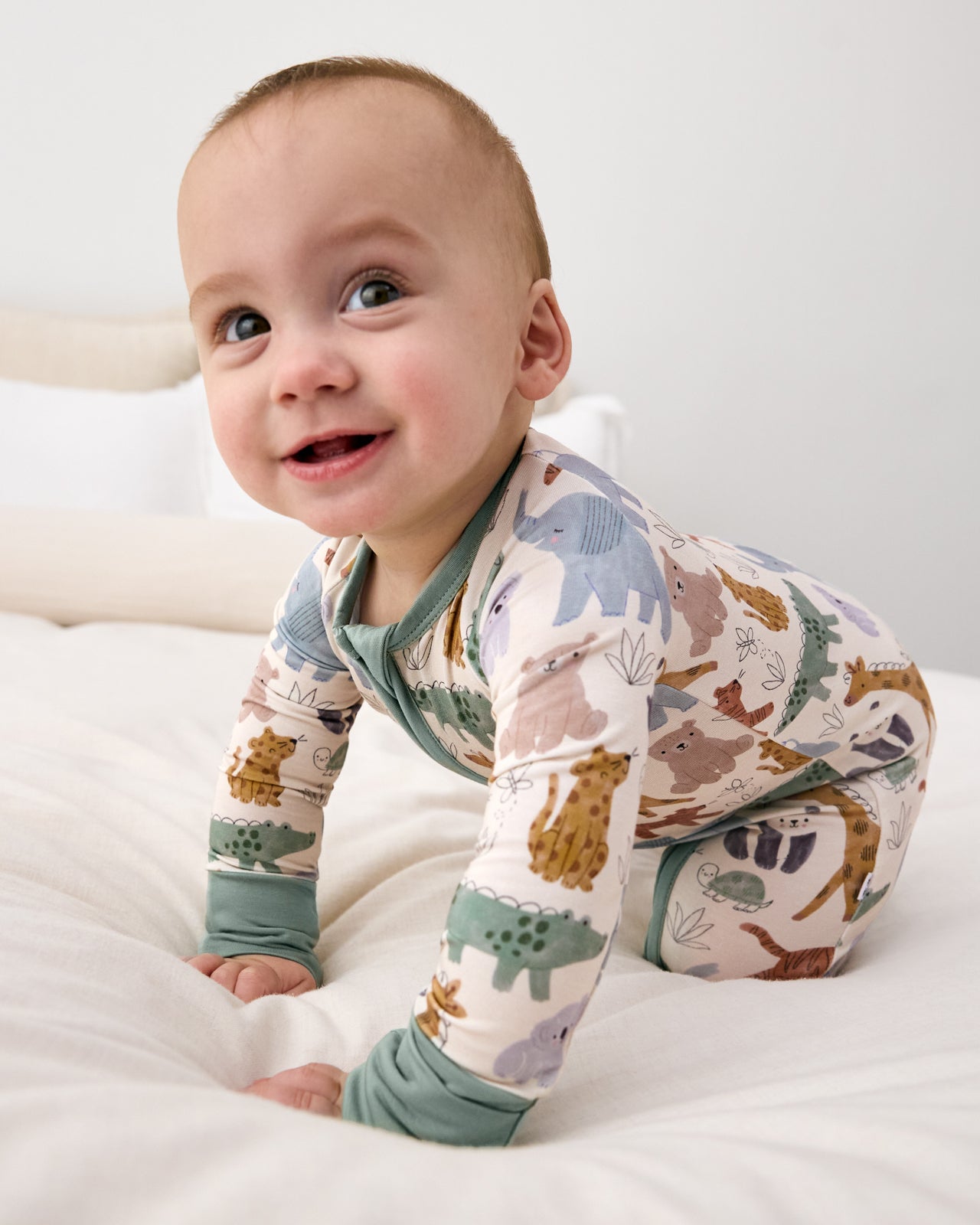 Crawling baby wearing the Sweet Safari Newborn Zippy