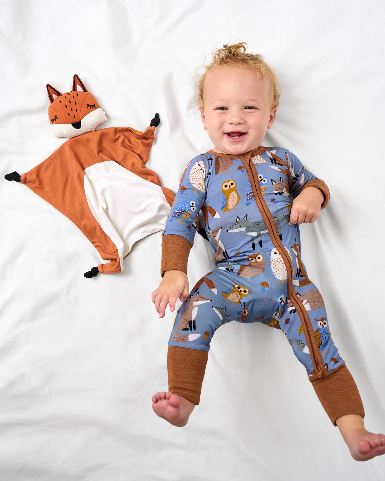 Baby laying next to the Felix the Fox Sleepyhead Lovey