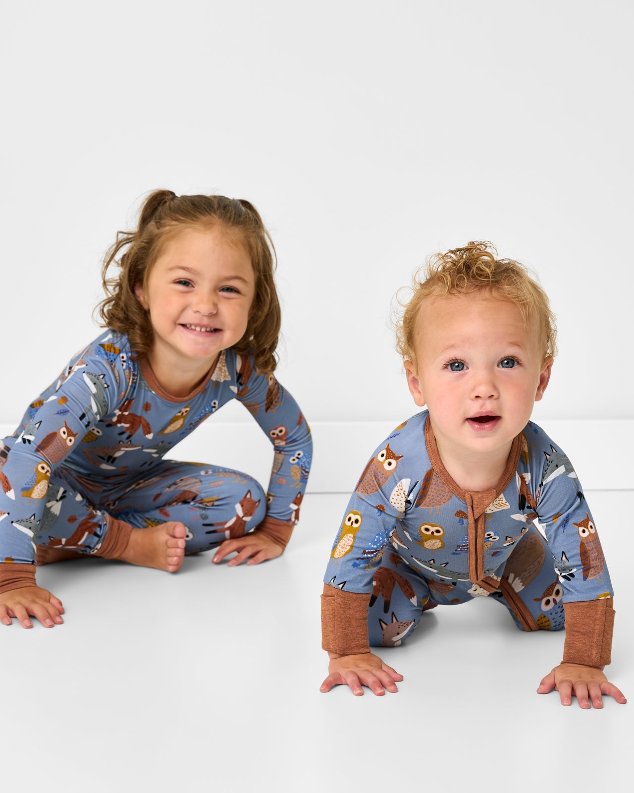 Two children wearing matching Twilight Pals bamboo pajamas for Fall