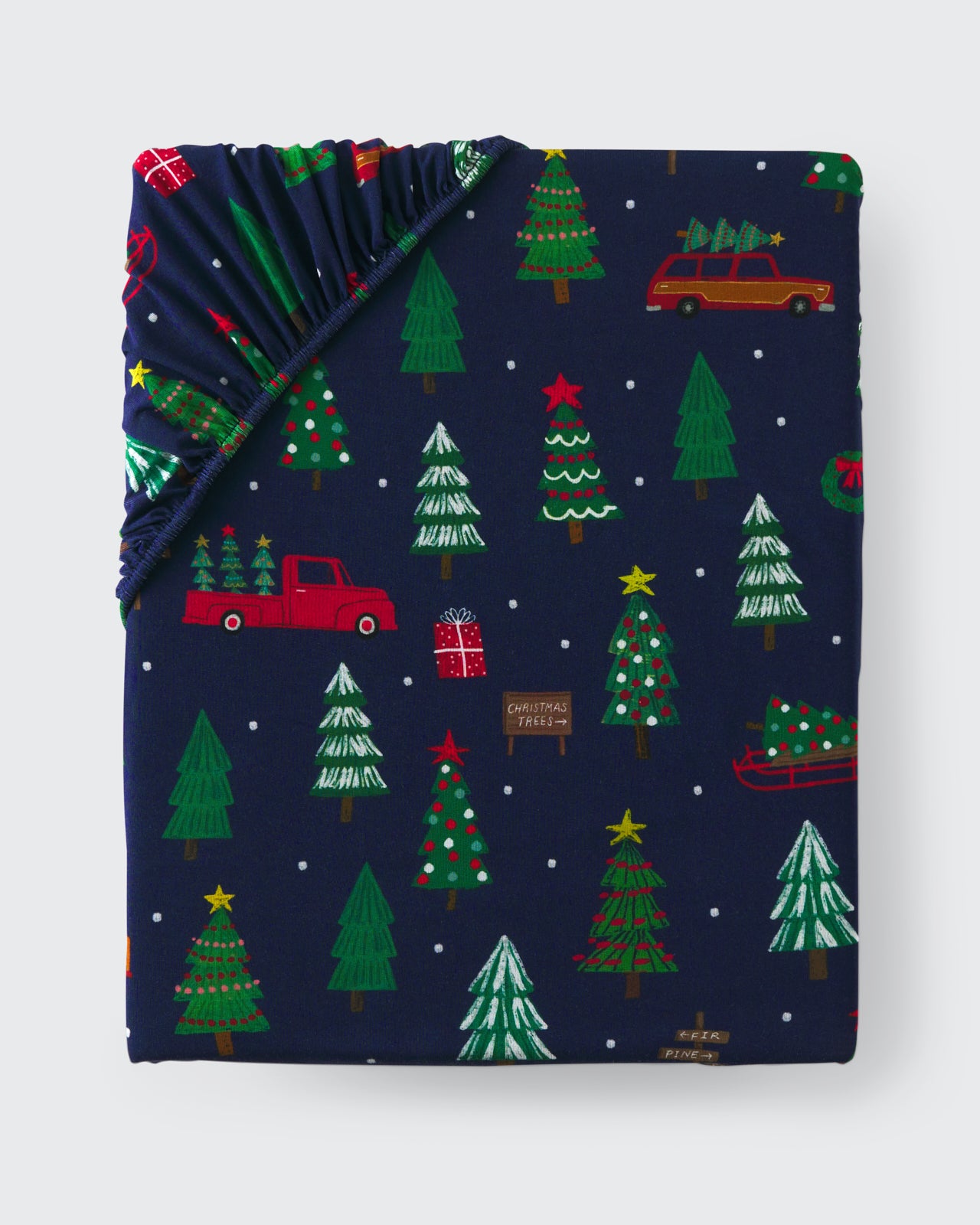 Flat lay of the Navy Tree Traffic Fitted Crib Sheet