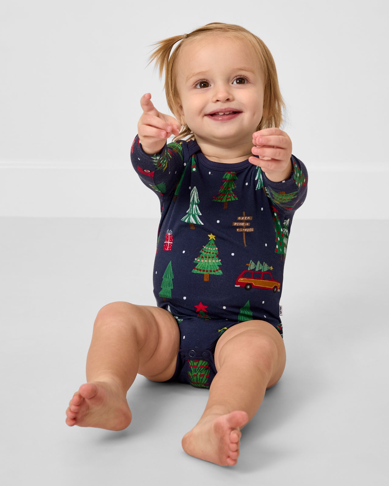 Sitting baby wearing the Navy Tree Traffic Bodysuit