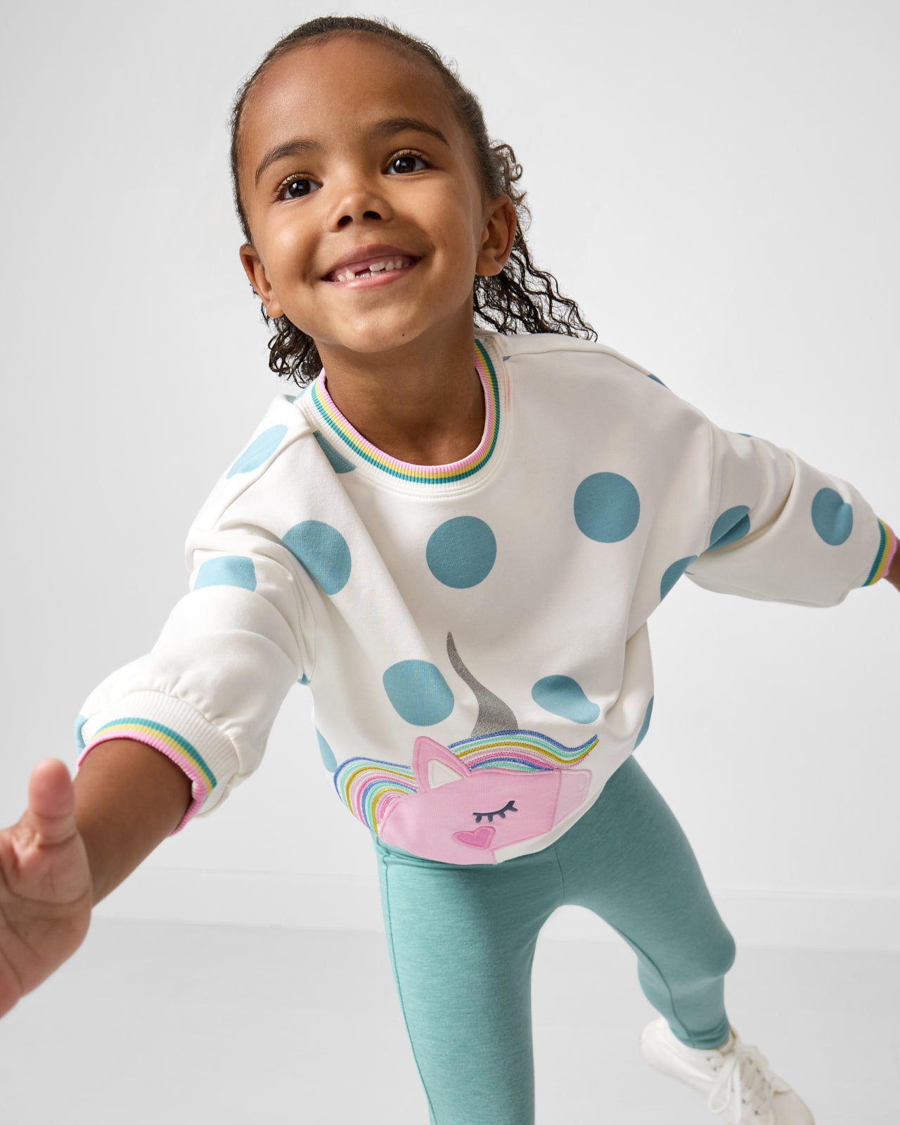 Child in motion wearing the Unicorn Drop Shoulder Crewneck