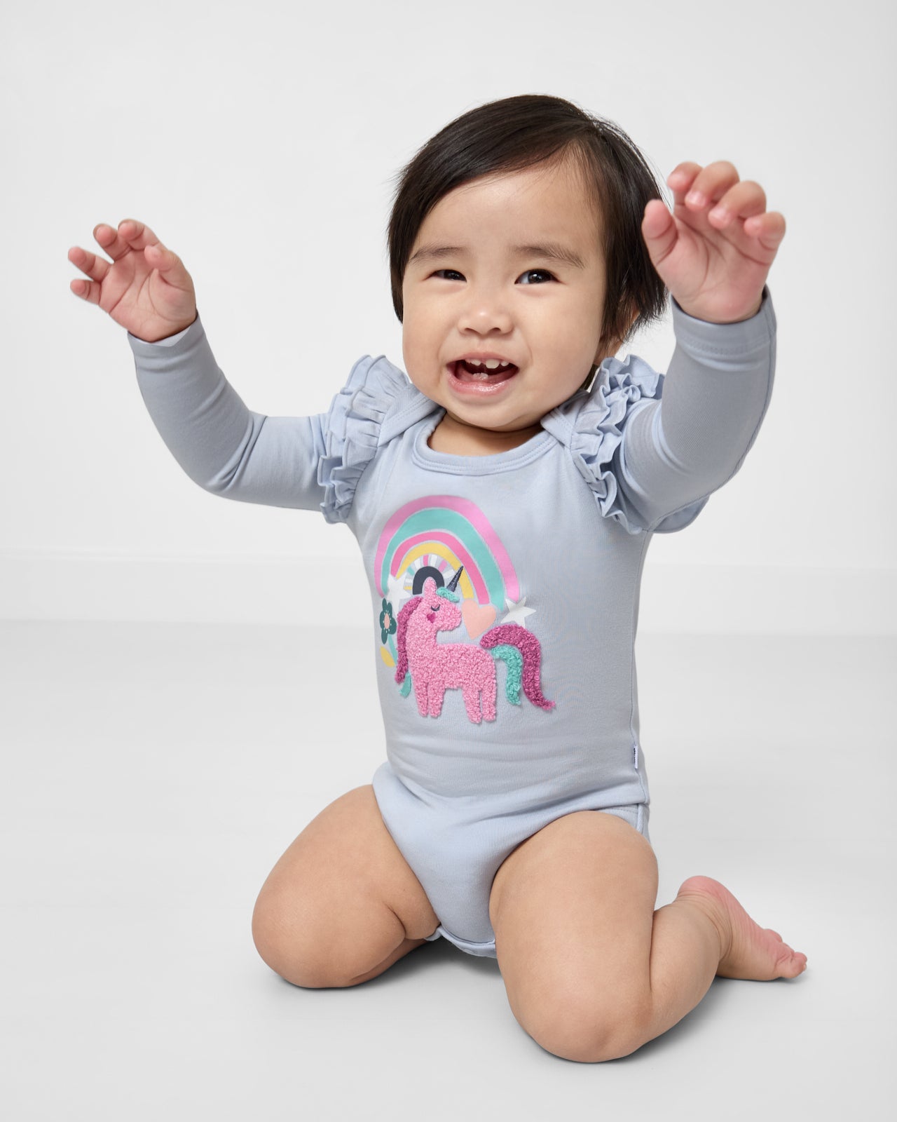 Posing child wearing the Unicorn Flutter Bodysuit