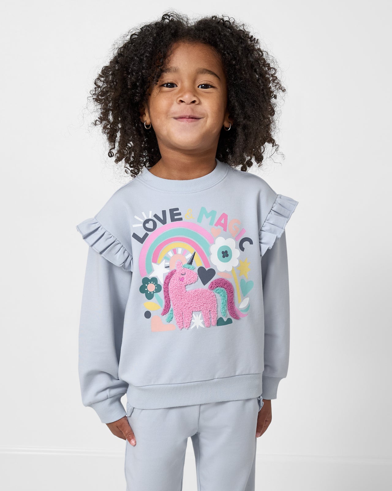 Girl wearing the Unicorn Ruffle Crewneck