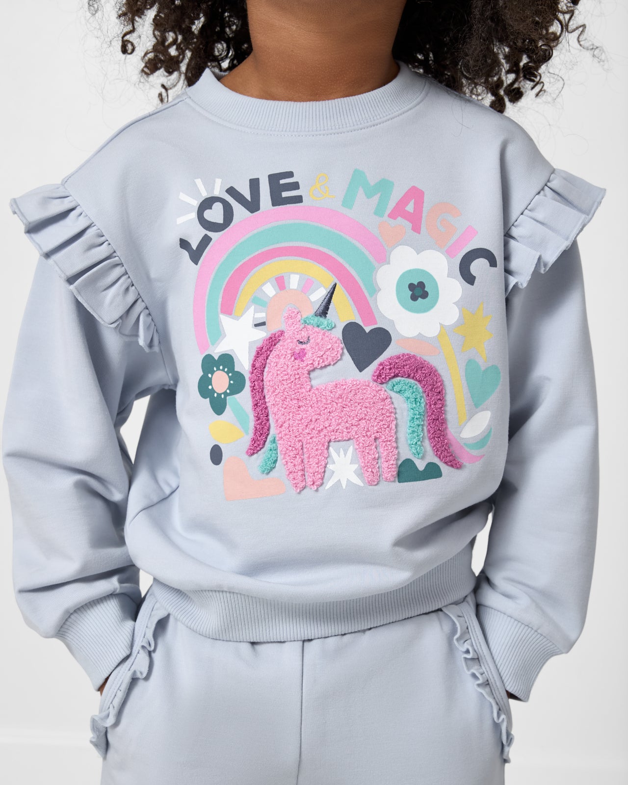 Close up of the graphic detail on the Unicorn Ruffle Crewneck