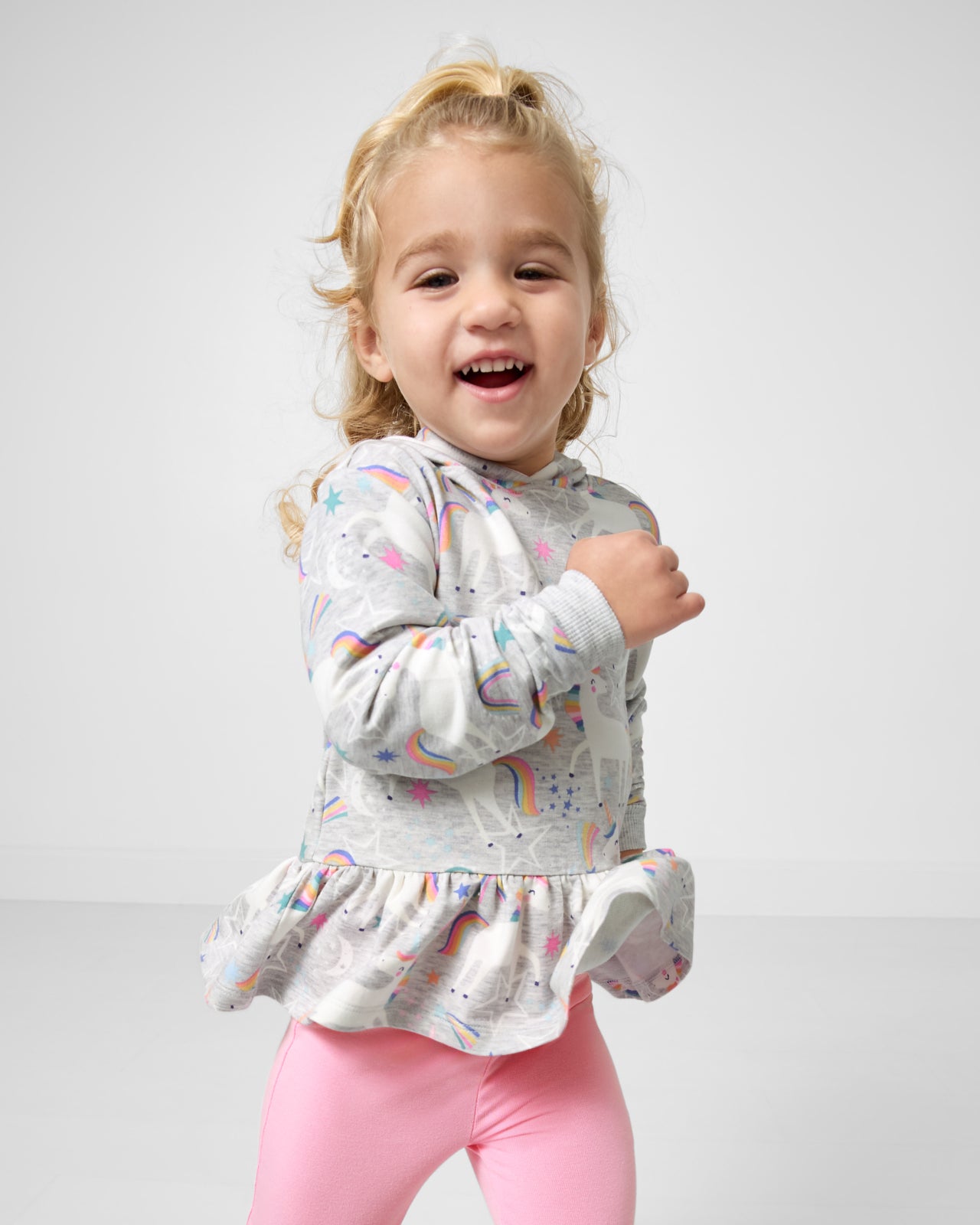 Running child wearing the Unicorn Dance Peplum Hooded Tee