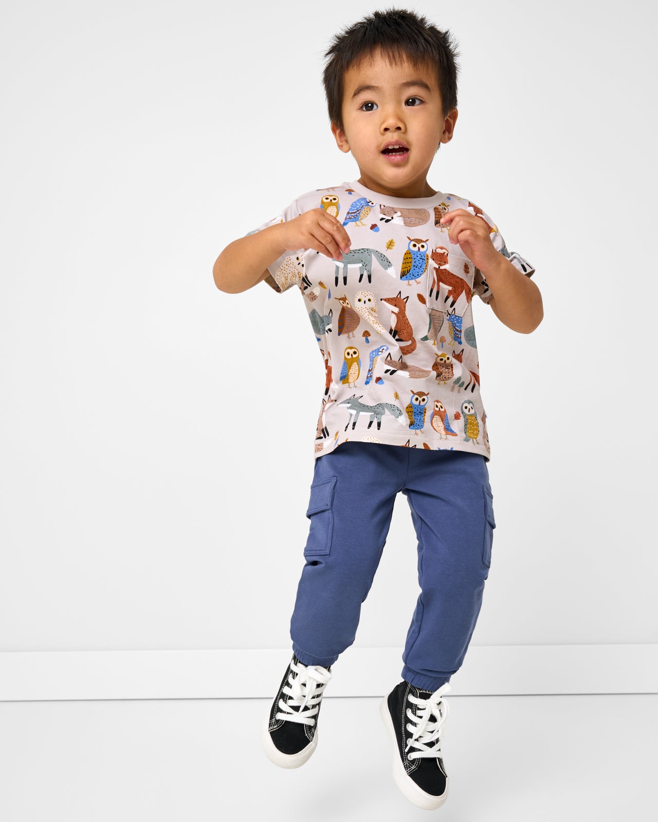 Jumping boy wearing the Vintage Navy Cargo Jogger with a Twilight Pals tee