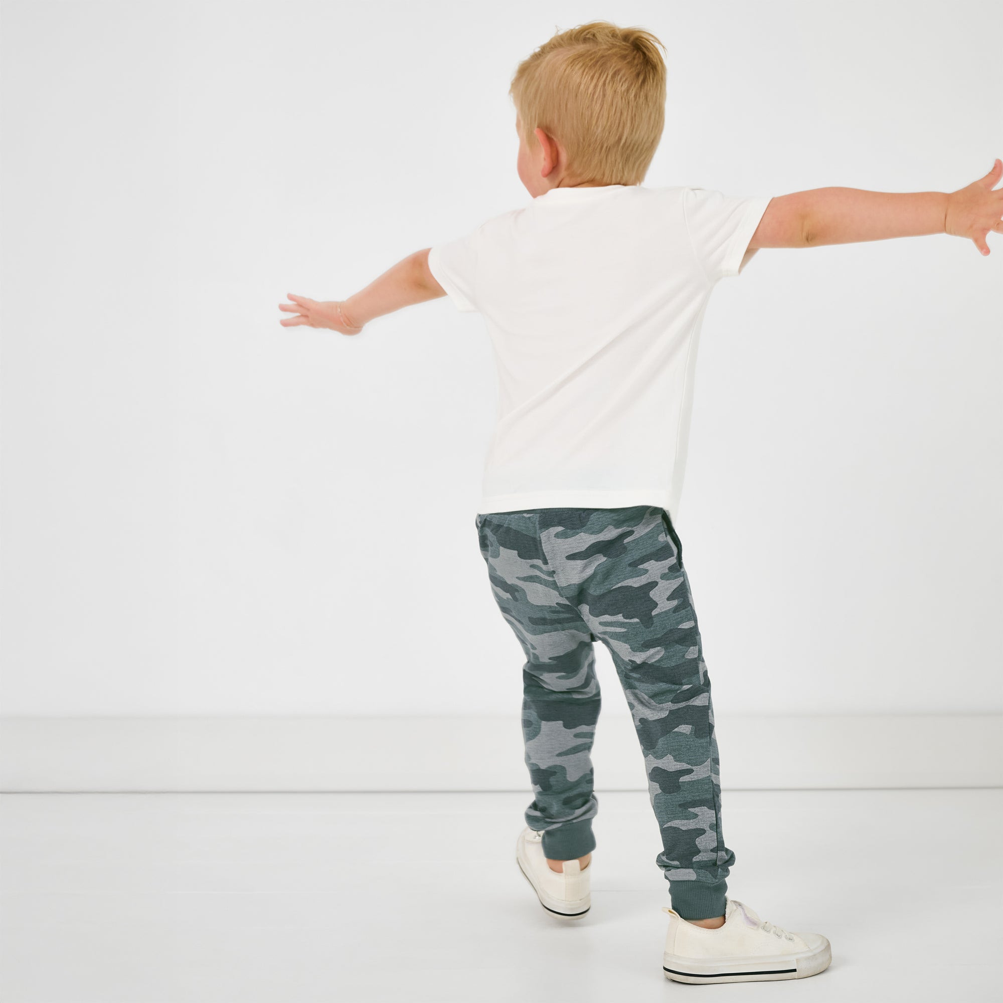Child in motion wearing the Vintage Camo Jogger