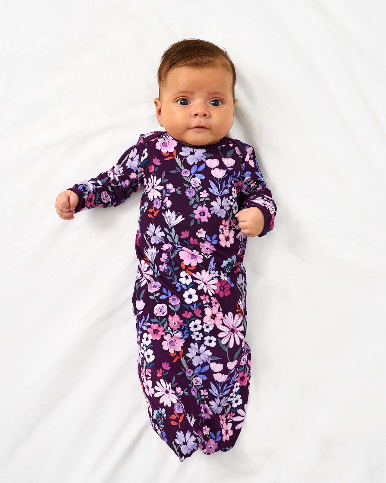 Aerial view of baby in the Violet Meadow Infant Gown