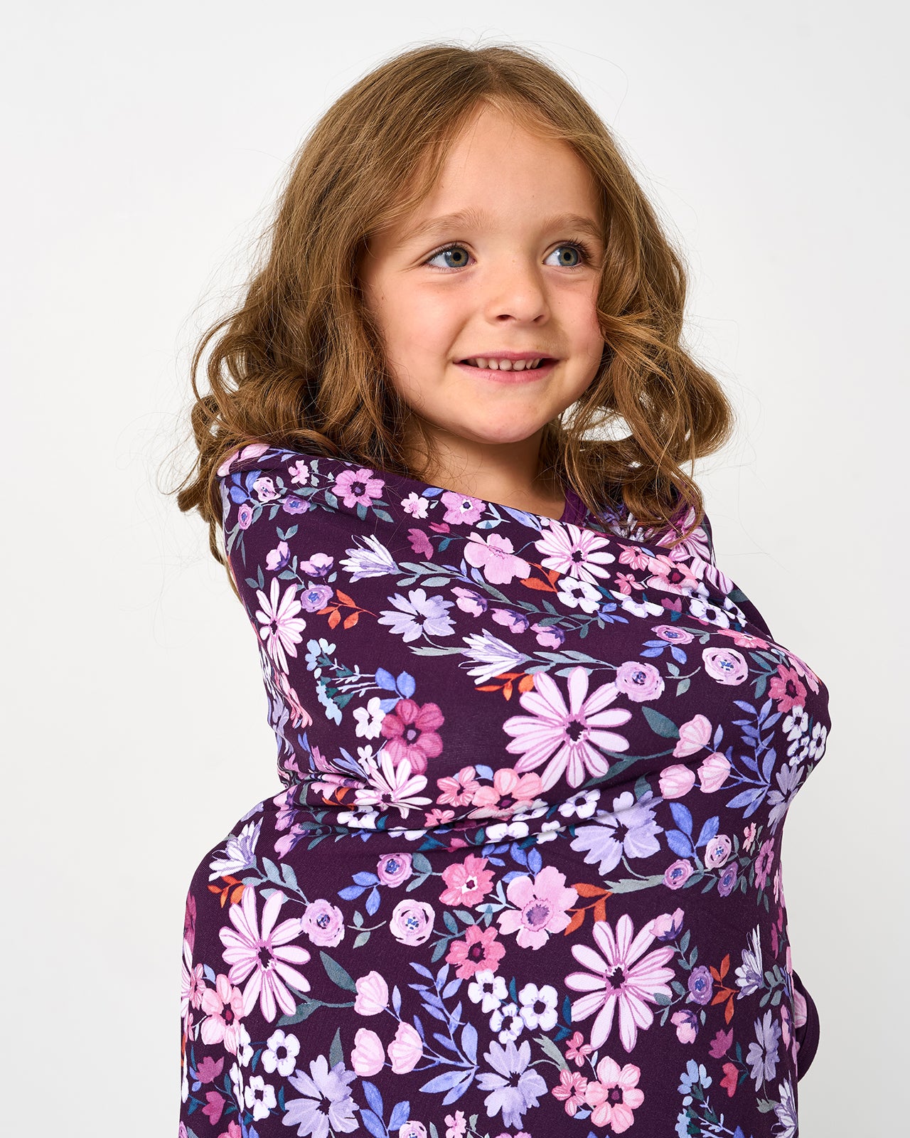 Close up of girl wrapped in the Violet Meadow Large Cloud Blanket®